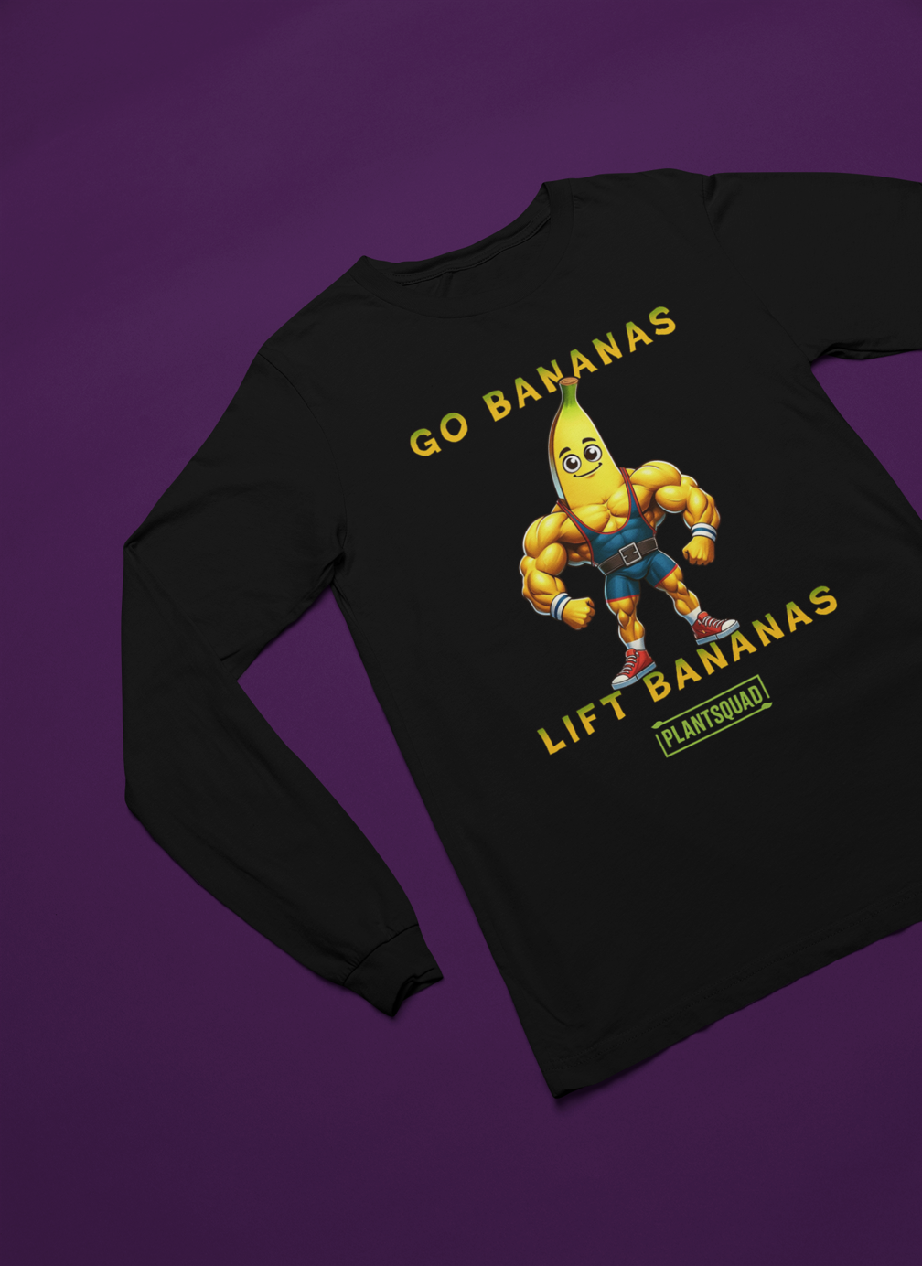 The Plantsquad Banana "Go Bananas Lift Bananas" - Unisex Long Sleeve T-Shirt features a muscular cartoon banana character wearing blue shorts and white shoes. The text above the banana says, "GO BANANAS," and the text below says, "LIFT BANANAS." Perfect for fitness enthusiasts embracing a plant-based lifestyle, it sports the logo "PLANTSQUAD" at the bottom.