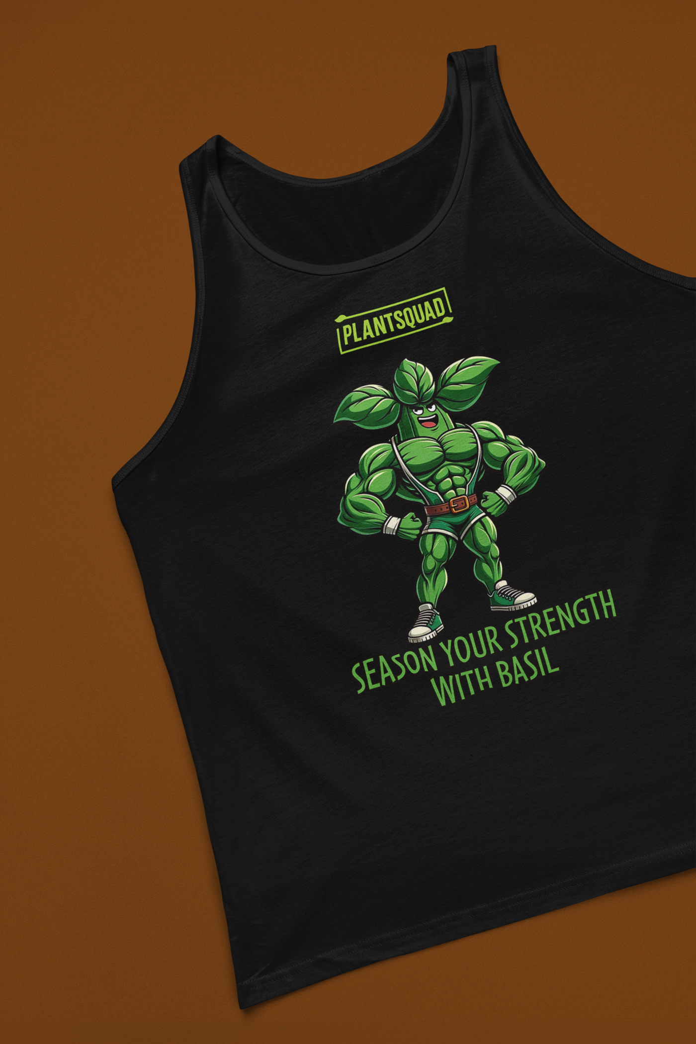 A black, plant-based tank top featuring a muscular, anthropomorphic basil plant character flexing its muscles. Above the character, text reads "PLANTSQUAD," and below it says "Season Your Strength with Basil." Perfect for those seeking vegan gym clothes or breathable workout apparel, this is the Plantsquad Basil "Season Your Strength With Basil" - Unisex Tank Top.