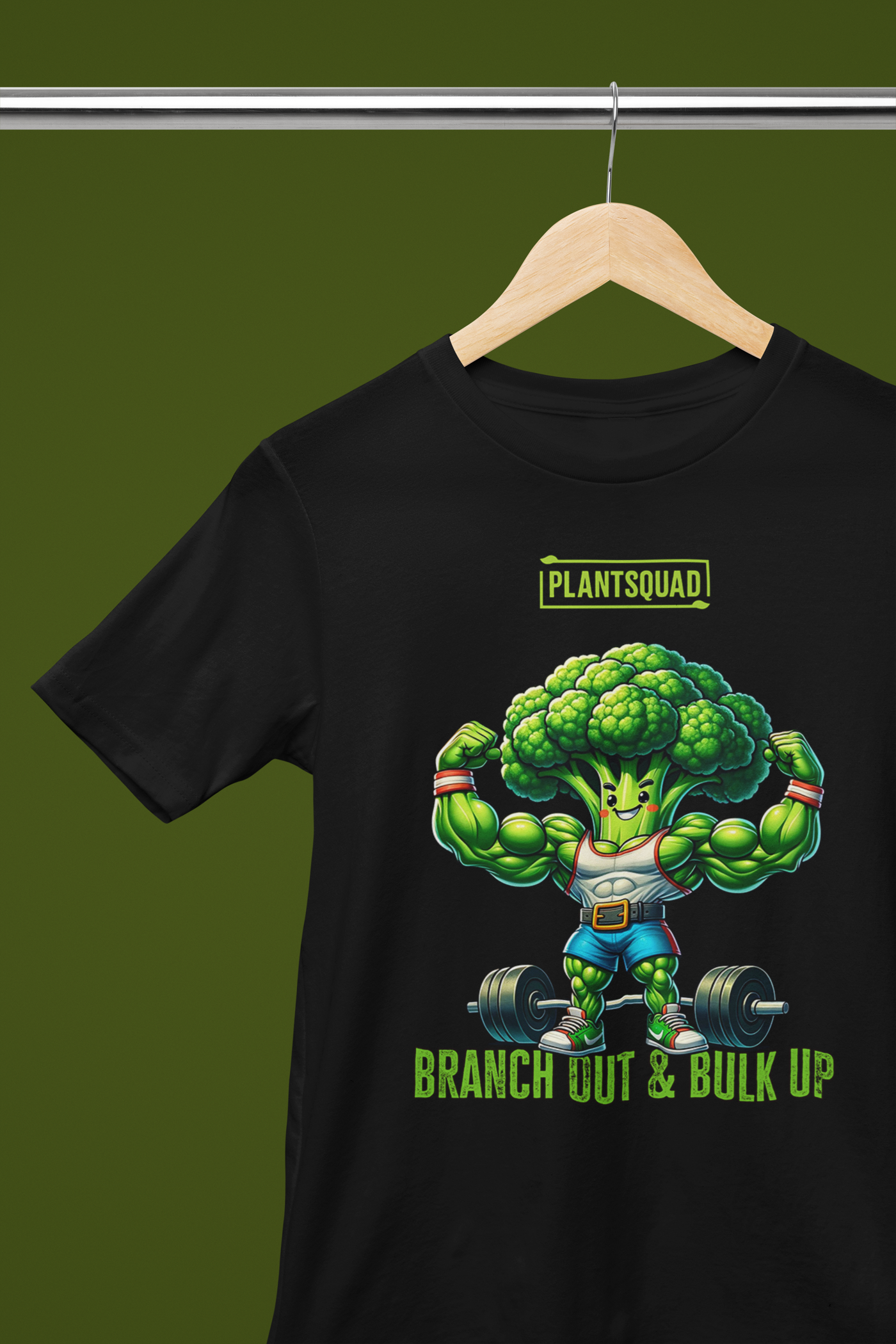 A black T-shirt features a cartoon broccoli character flexing its arms and lifting dumbbells. Above the character, the bold text reads "PLANTSQUAD." Below, it says "BRANCH OUT & BULK UP!" The muscular broccoli exudes confidence, embodying the power of Plantsquad Broccoli "Branch Out & Bulk Up" - Unisex T-Shirt.