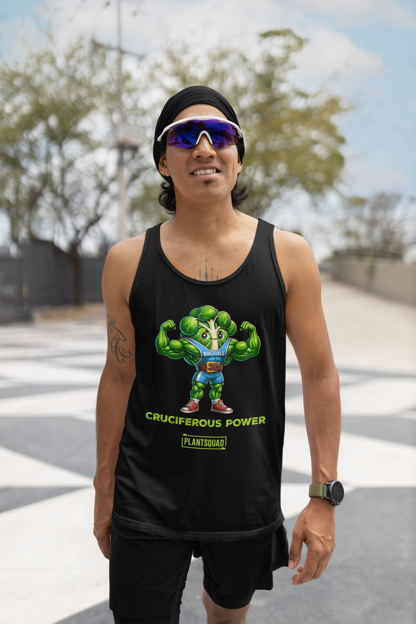 A black vegan tank top featuring a muscular animated character resembling broccoli with the word "BRUHLS" on its hat. The character is flexing its arm muscles. Text below reads "CRUCIFEROUS POWER" and "PLANTSQUAD," perfect for those embracing a plant-based lifestyle or looking for workout clothing, as seen in the Plantsquad Brussel Sprout "Cruciferous Power" - Unisex Tank Top.