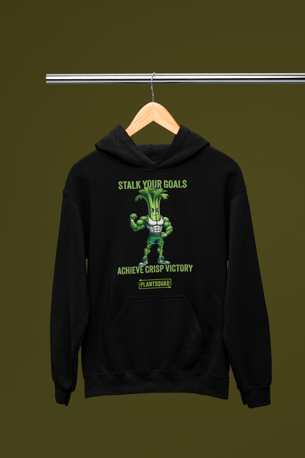 The Plantsquad Celery "Stalk Your Goals Achieve Crisp Victory" - Unisex Hoodie features a muscular anthropomorphic celery stalk. Green text above reads, "STALK YOUR GOALS," and below reads, "ACHIEVE CRISP VICTORY." The phrase "PLANTSQUAD" is written beneath the celery figure. This vegan hoodie is perfect for embracing a plant-based lifestyle and weight lifting apparel needs.