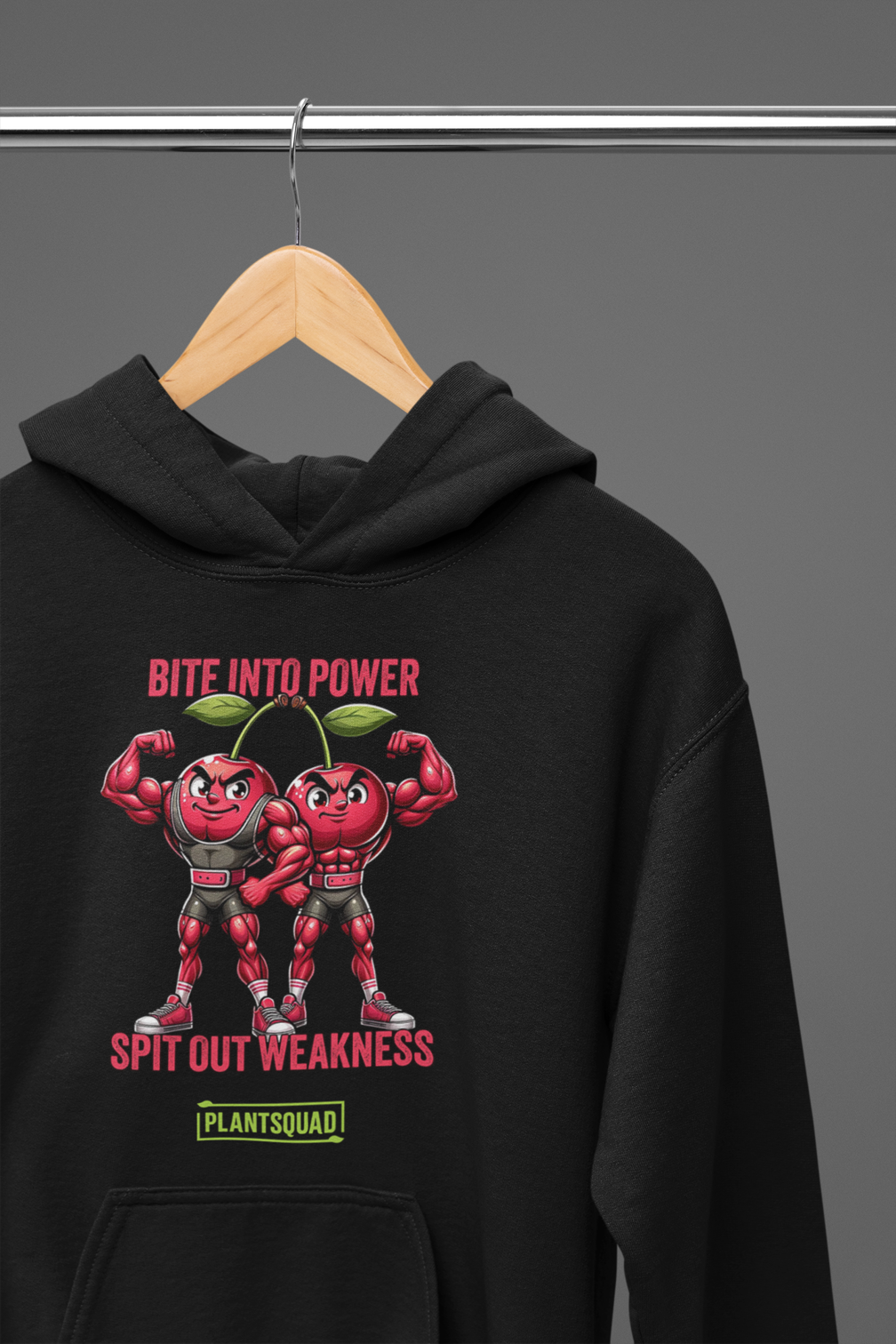Sure, here is the sentence with the product name replaced:
A black hoodie featuring an illustration of two muscular tomatoes, one male and one female, flexing their biceps. The text reads, "Bite into Power, Spit Out Weakness," with the brand name "PlantSquad" below. Perfect for those embracing a vegan lifestyle and looking for a weight lifting hoodie with attitude. Introducing the **Plantsquad Cherries "Bite Into Power Spit Out Weakness" - Unisex Hoodie**!