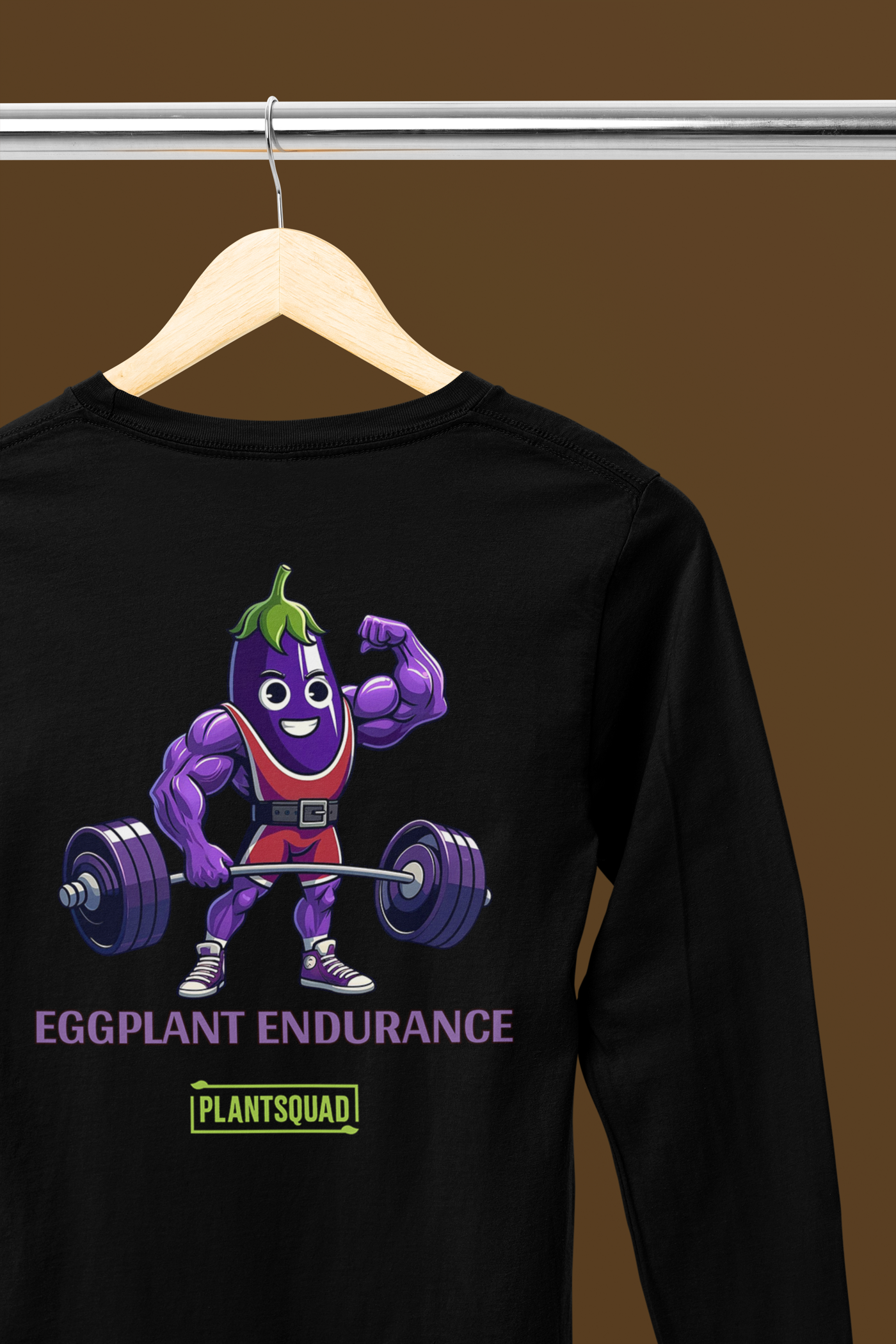 A black long-sleeve shirt featuring a cartoonish, muscular eggplant character lifting a barbell above its head. The text "EGGPLANT ENDURANCE" is written below the character, with the word "PLANTSQUAD" beneath in a green label. Perfect vegan fitness apparel for those who love plant-based clothing! The Plantsquad Eggplant "Eggplant Endurance" - Unisex Long Sleeve T-Shirt is perfect for showing off your plant-based strength and style.