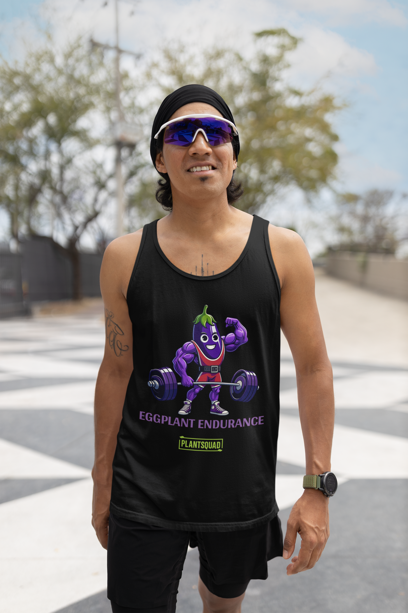Image of a black tank top featuring a cartoon eggplant character lifting a barbell. The eggplant has muscular arms, is wearing a headband, and smiling confidently. Below the character, the text reads "EGGPLANT ENDURANCE" with a small "PLANTSQUAD" logo underneath. Perfect Plantsquad Eggplant "Eggplant Endurance" - Unisex Tank Top!
