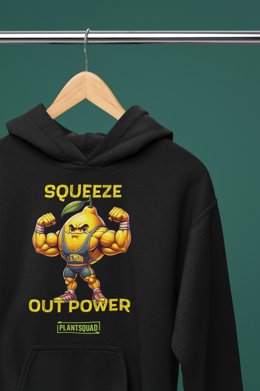 The Plantsquad Lemon "Squeeze Out Power" - Unisex Hoodie features a black design with a muscular lemon cartoon character flexing its arms. Above the character, the text reads "Squeeze" and below it "Out Power." The word "Lemon" is on the lemon character's chest, and "Plant Squad" is written at the bottom. Perfect for embracing a vegan lifestyle.