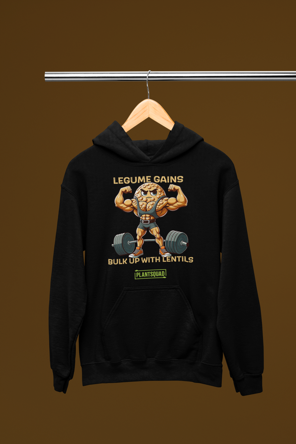 A black, plant-based hoodie featuring a muscular, anthropomorphic lentil character lifting a heavy barbell. The text above the character reads "LEGUME GAINS" and below it says "BULK UP WITH LENTILS." Perfect for gym enthusiasts embracing a vegan lifestyle, the logo "PLANTSQUAD" appears at the bottom. This is the Plantsquad Lentil "Legume Gains Bulk Up With Lentils" - Unisex Hoodie.