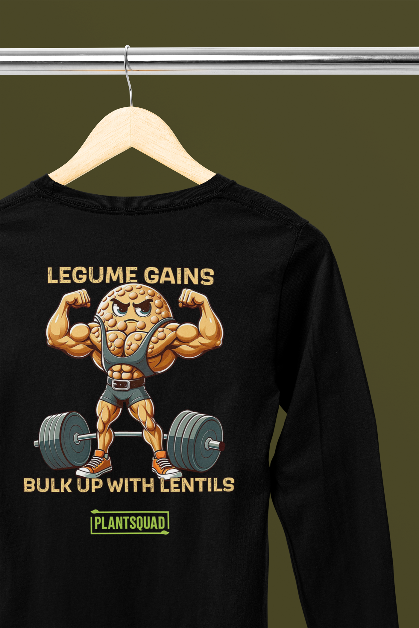 A Plantsquad Lentil "Legume Gains Bulk Up With Lentils" - Unisex Long Sleeve T-Shirt featuring a cartoon lentil with muscular arms lifting a barbell. The text reads "LEGUME GAINS" at the top, "BULK UP WITH LENTILS" in the middle, and "PLANTSQUAD" at the bottom. Perfect for those embracing a vegan lifestyle.