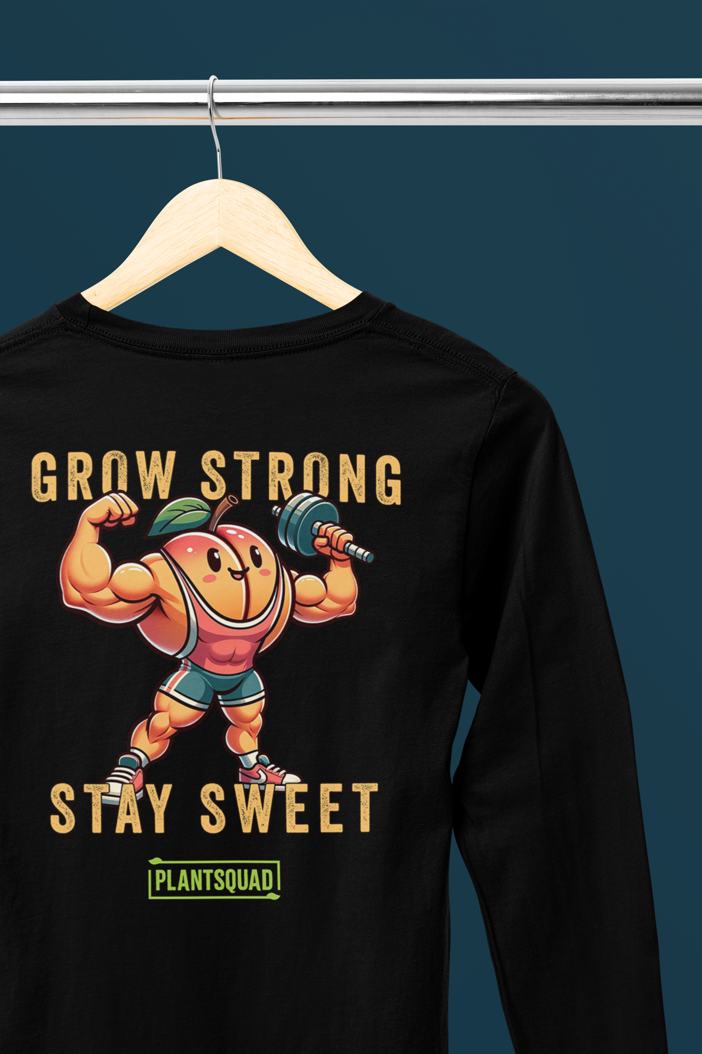 Plantsquad Peach "Grow Strong Stay Sweet" - Unisex Long Sleeve T-Shirt featuring a muscly peach cartoon flexing in athletic wear, holding a dumbbell. Text above reads "GROW STRONG," and below, "STAY SWEET." Perfect for those embracing a plant-based lifestyle, "PLANTSQUAD" is printed at the bottom.