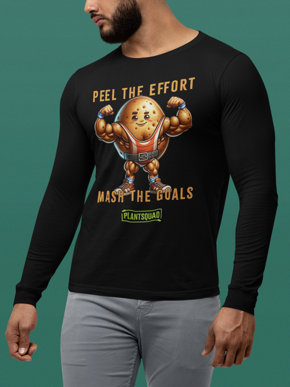 A black long-sleeve shirt features a muscly potato cartoon flexing its arms. Above it is the text "Peel the Effort," and below it reads "Mash the Goals." Embrace a plant-based lifestyle with this fun design, complete with a green label at the bottom reading "PLANTSQUAD." This is available as the Plantsquad Potato "Peel The Effort Mash The Goals" - Unisex Hoodie.