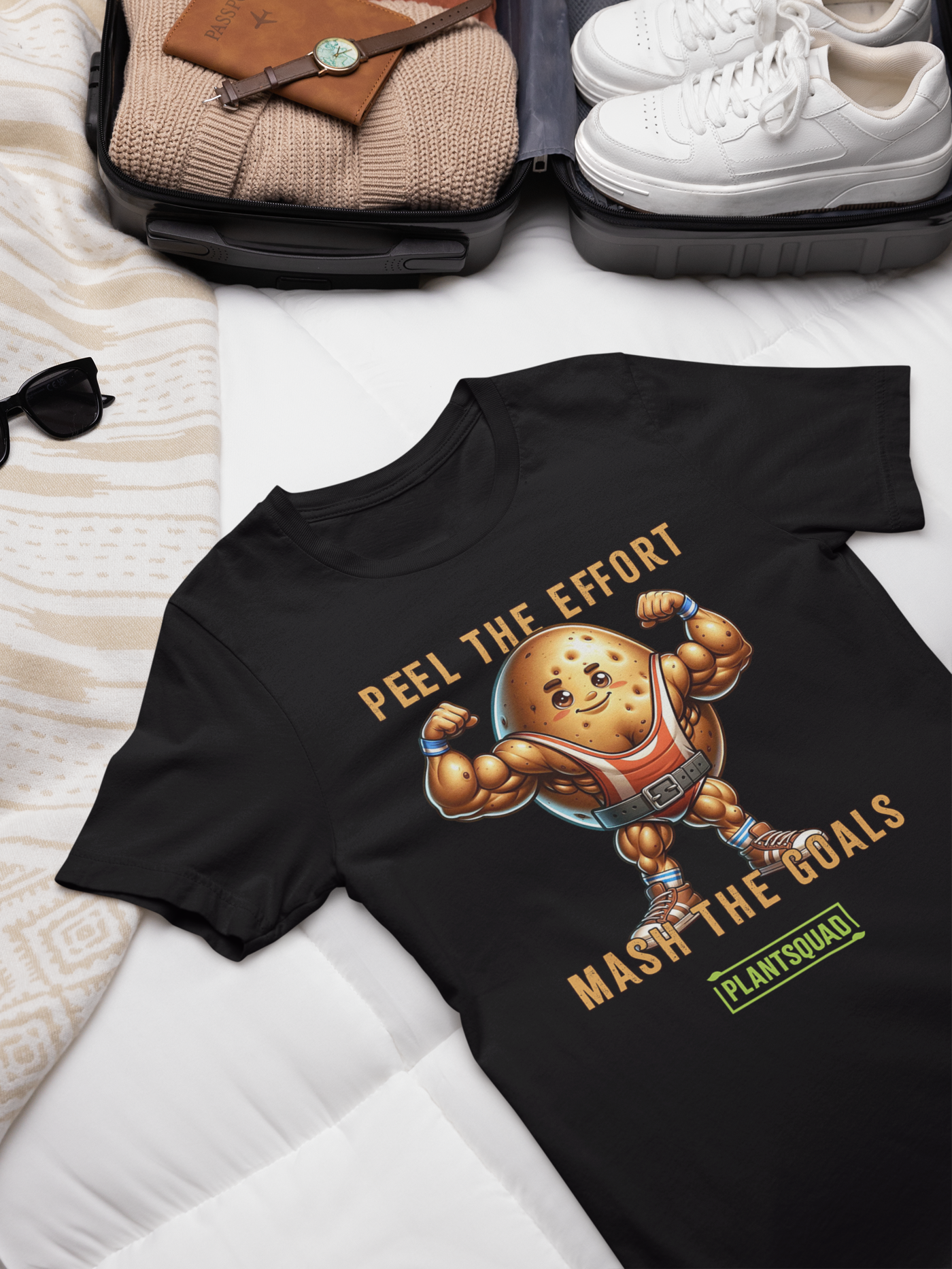 A black T-shirt featuring an illustration of a muscular potato flexing its arms. Above the potato, text reads "PEEL THE EFFORT." Below, text reads "MASH THE GOALS." Perfect for fitness enthusiasts, this vegan T-shirt showcases a small green rectangular logo at the bottom that says "PLANTSQUAD. The product name is Plantsquad Potato "Peel The Effort Mash The Goals" - Unisex T-Shirt.