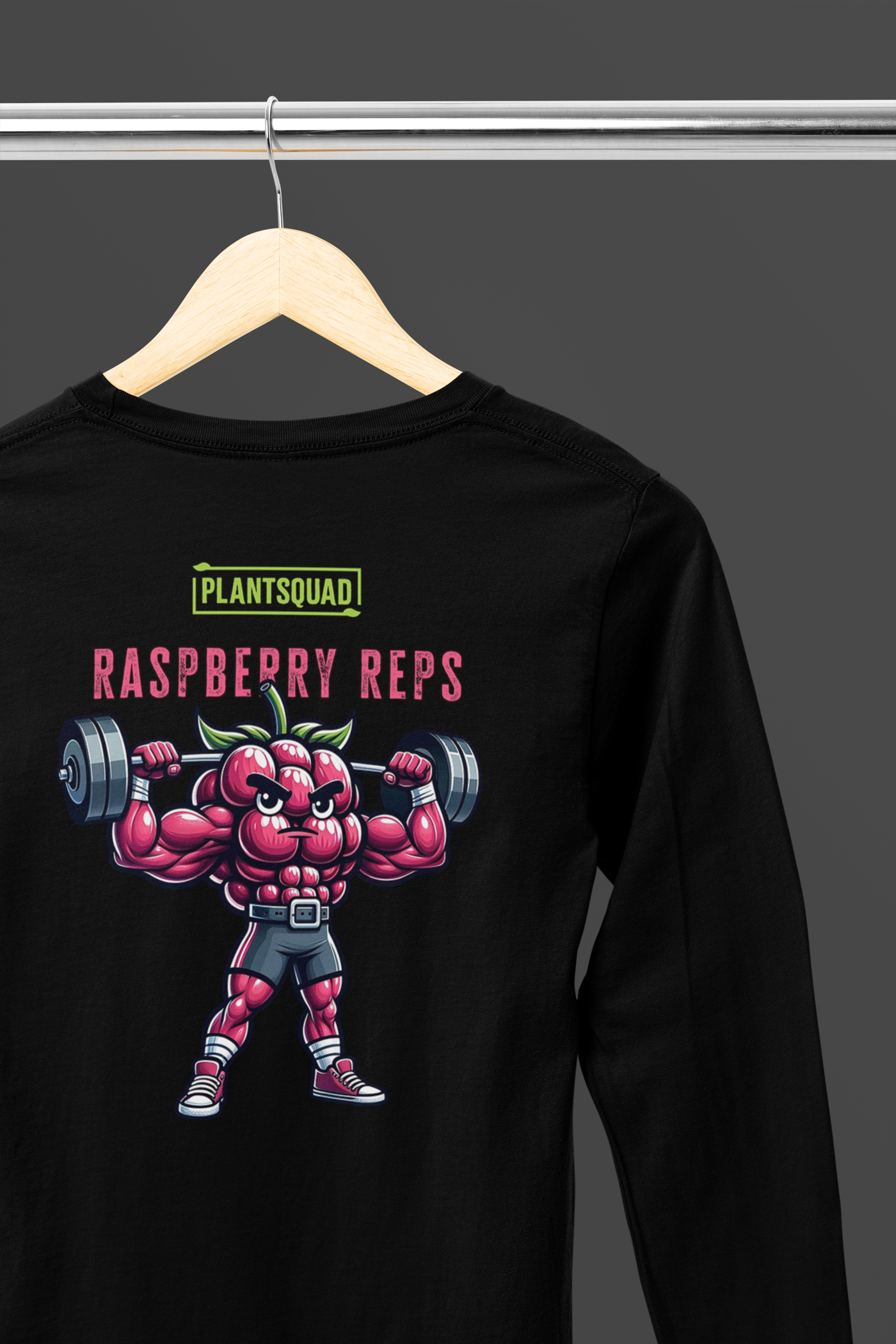A Plantsquad Raspberry "Raspberry Reps" - Unisex Long Sleeve T-Shirt featuring a muscular, anthropomorphic raspberry lifting dumbbells. Above the raspberry, text reads "PLANTSQUAD," and below, "RASPBERRY REPS" is printed in bold red and white letters. Perfect for fitness enthusiasts who embrace a plant-based, vegan lifestyle.