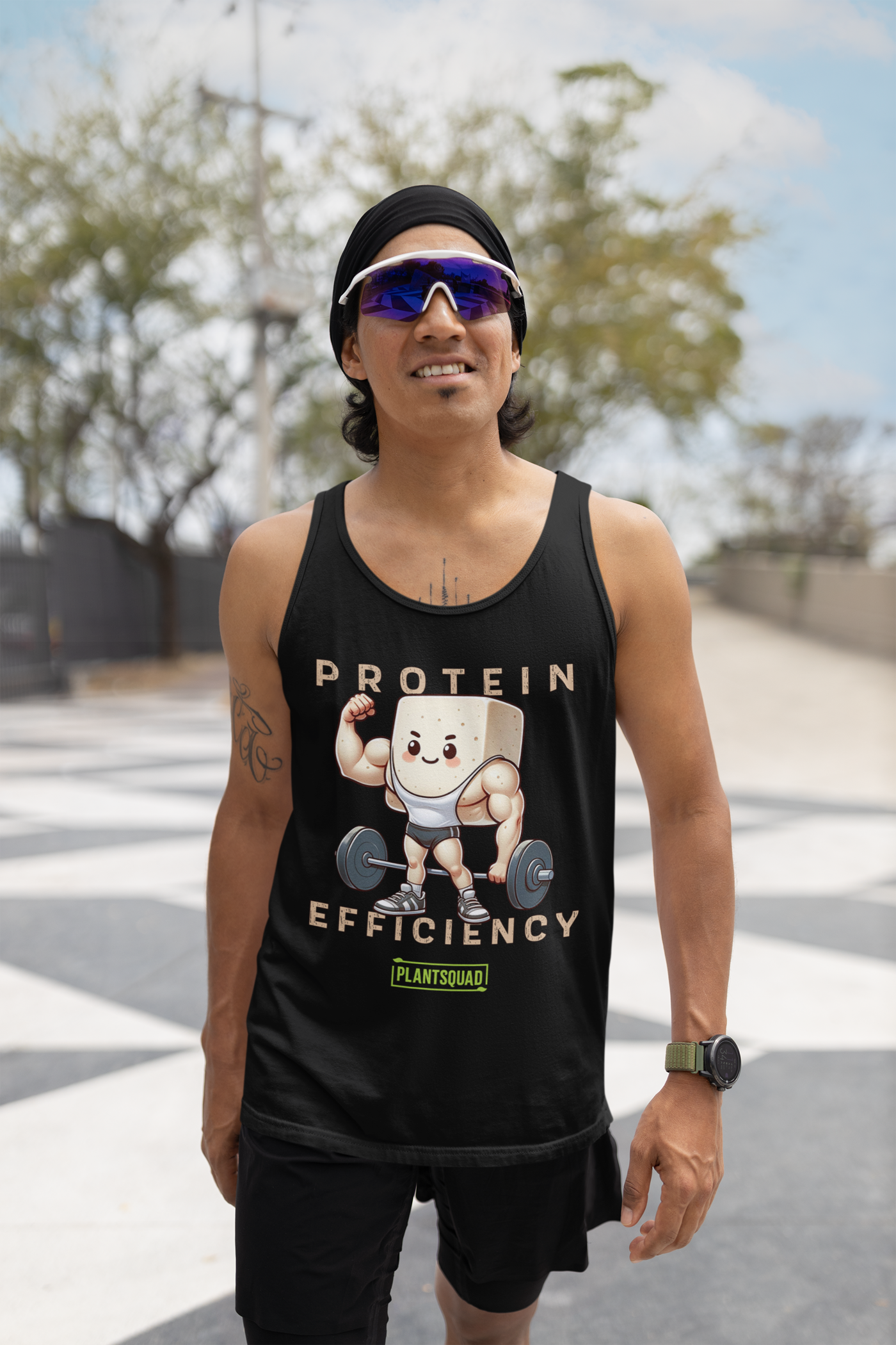 The Plantsquad Tofu "Protein Efficiency" - Unisex Tank Top features a graphic of a cartoon tofu block lifting a barbell. The tofu, dressed in a weightlifting singlet and sneakers, flexes its muscles. Perfect for gym enthusiasts embracing a plant-based lifestyle, the text reads "PROTEIN EFFICIENCY" and "PLANTSQUAD," and the breathable fabric ensures comfort.