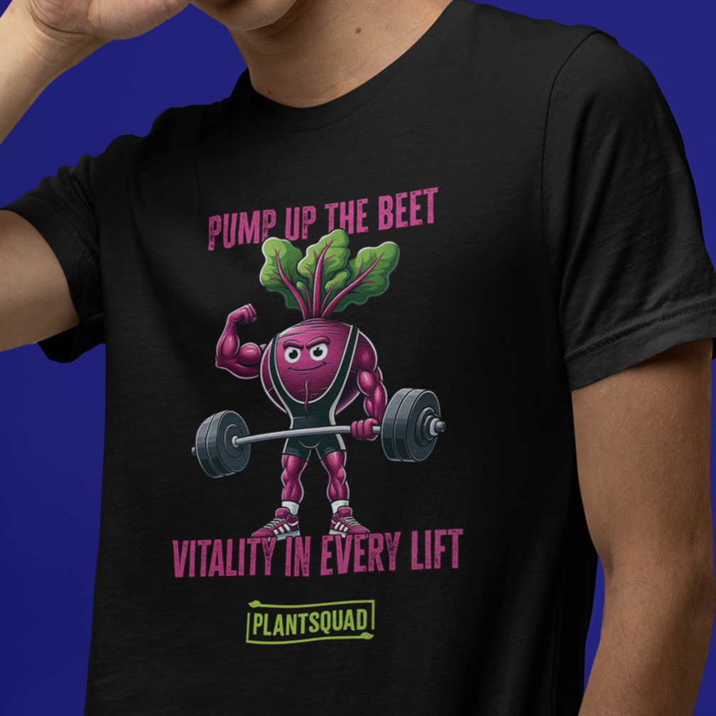 A person is wearing a black t-shirt featuring a muscular cartoon beet lifting a barbell. The text on the shirt reads "PUMP UP THE BEET" above the beet and "VITALITY IN EVERY LIFT" below it, with "PLANTSQUAD" at the bottom.