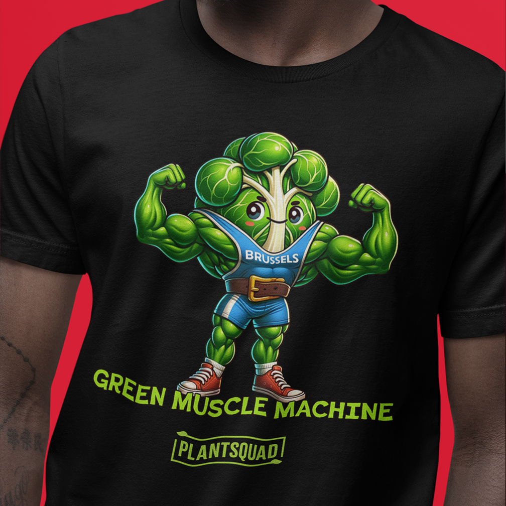 A person wearing a black t-shirt with an illustration of a muscular Brussels sprout flexing its arms. The vegetable is dressed like a bodybuilder and labeled "BRUSSELS." The text below reads "GREEN MUSCLE MACHINE" and "PLANTSQUAD" on a red background.