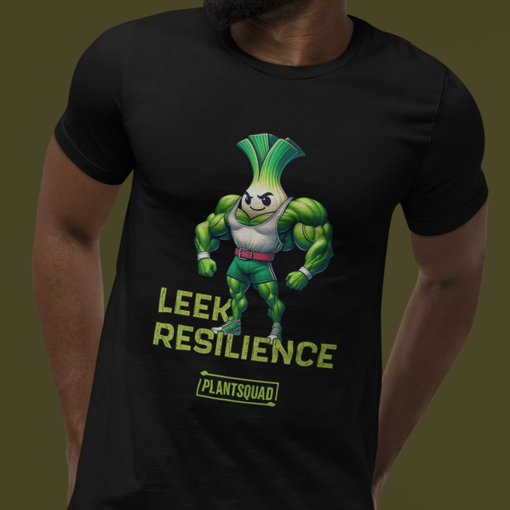 A person wearing a black t-shirt featuring a muscular leek character with flexed arms, a determined expression, and the text "Leek Resilience" and "Plantsquad" beneath the character.