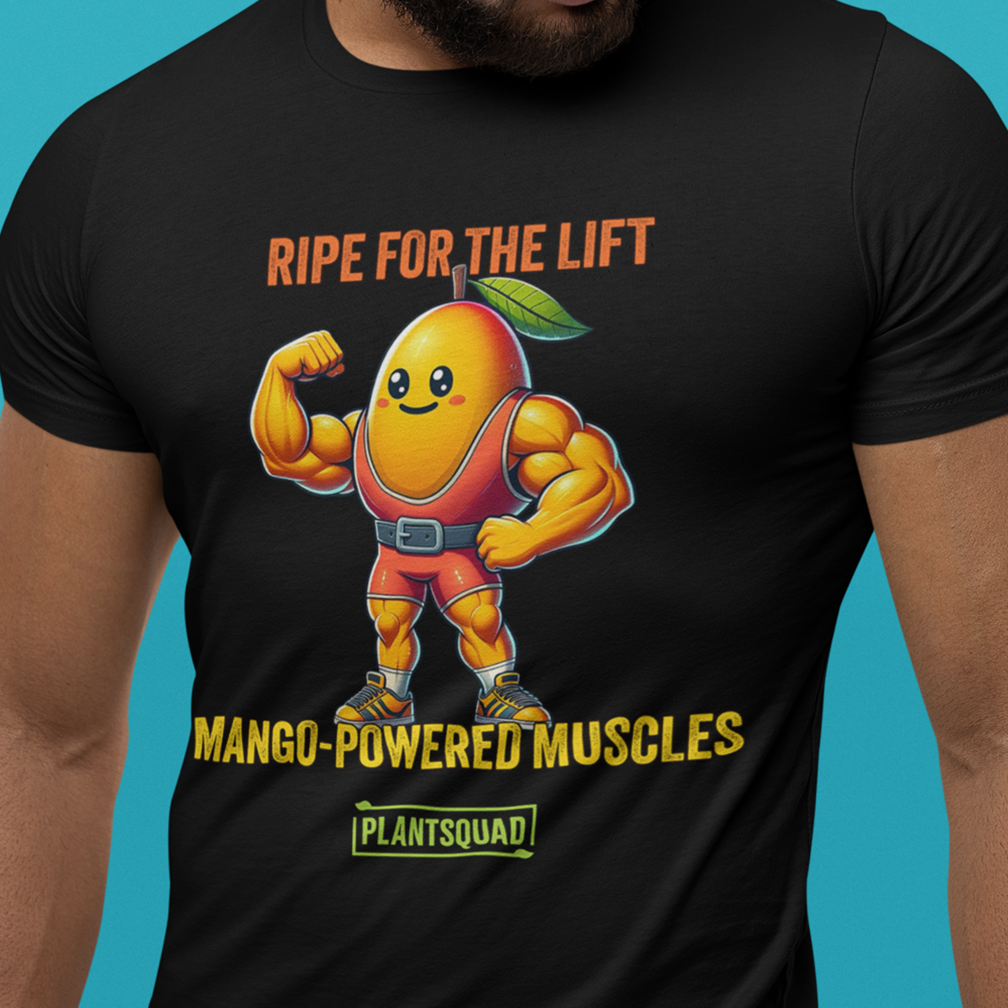 A person wearing a black T-shirt featuring an illustration of a muscular mango character flexing its biceps. The text reads "RIPE FOR THE LIFT," "MANGO-POWERED MUSCLES," and "PLANTSQUAD" below the character. The background is a bright blue color.