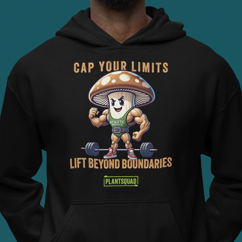 A person wearing a black hoodie featuring a cartoon mushroom character lifting a barbell with the text "Cap Your Limits" above and "Lift Beyond Boundaries" below. The brand name "Plantsquad" is displayed at the bottom.