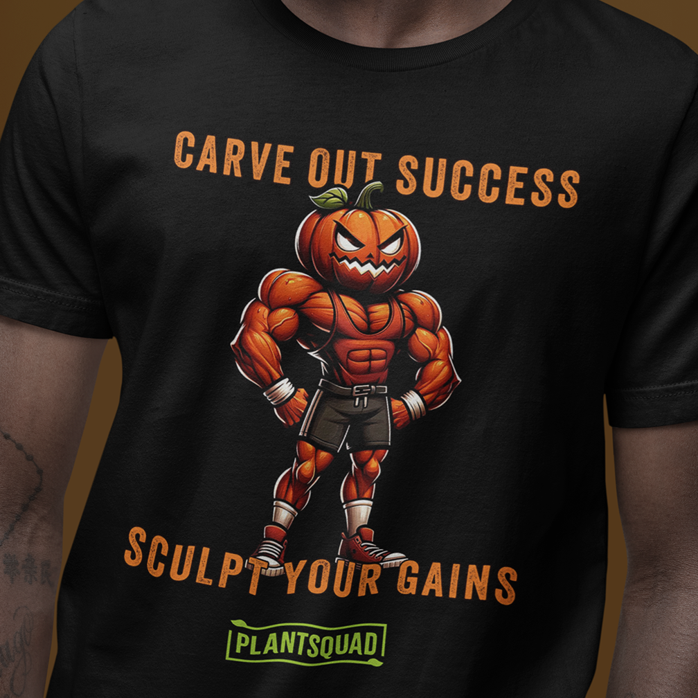 A person wears a black T-shirt featuring a muscular cartoon pumpkin lifting its arms with a confident expression. The text reads, "CARVE OUT SUCCESS" above the pumpkin, and "SCULPT YOUR GAINS" below it, with "PLANTSQUAD" at the bottom.