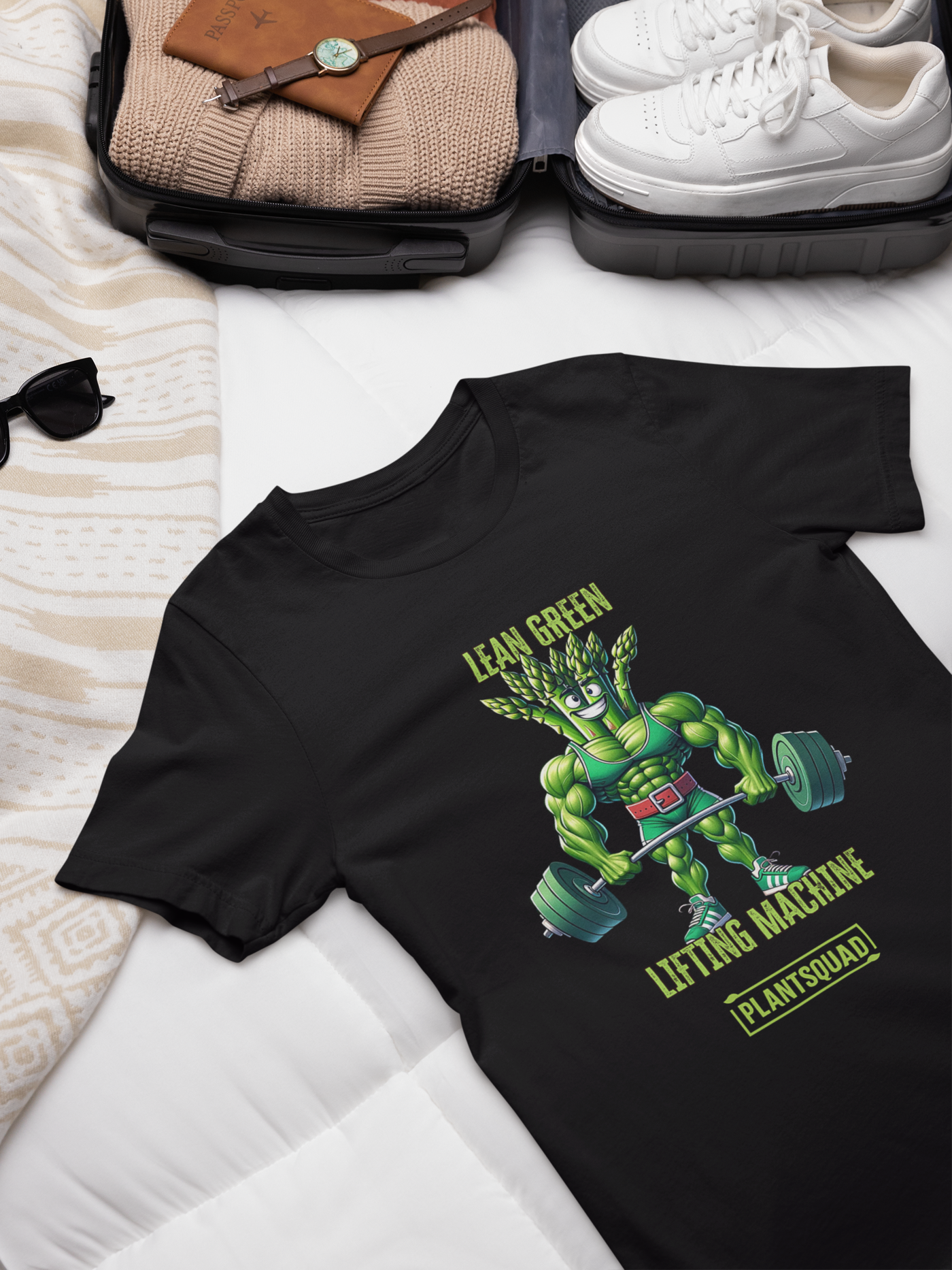 A black T-shirt featuring a muscular green creature holding barbells, under the text "LEAN GREEN LIFTING MACHINE." Below the graphic, a text box proudly reads "Plantsquad Asparagus 'Lean Green Lifting Machine' - Unisex T-Shirt" to represent your team.