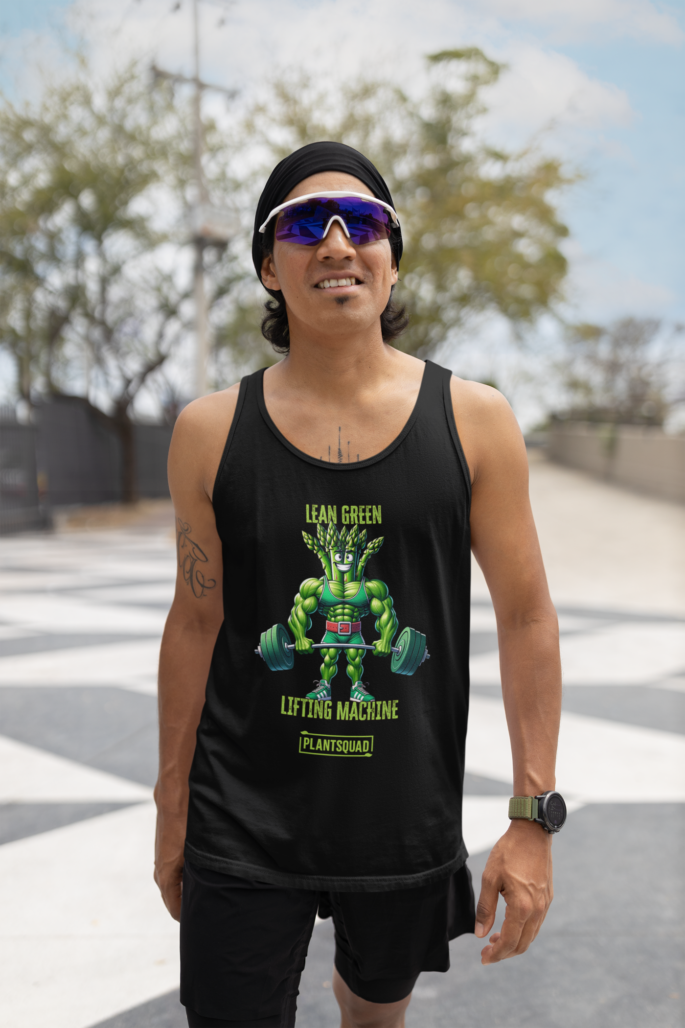 A black vegan Plantsquad Asparagus "Lean Green Lifting Machine" - Unisex Tank Top featuring an illustration of a muscular, green plant-like character lifting a barbell with heavy weights. Above the character is the text "Lean Green Lifting Machine" and below is the text "Plant Squad." Perfect for those embracing a plant-based lifestyle.