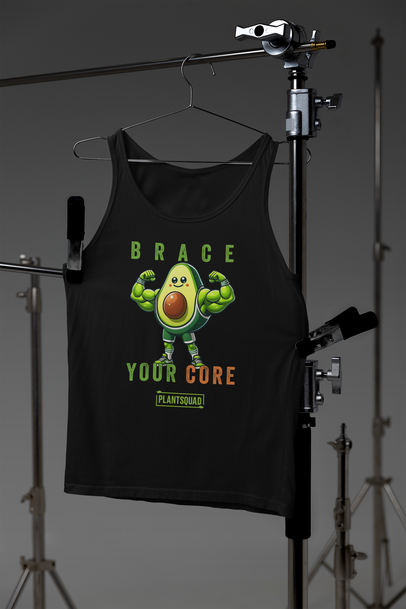 A Plantsquad Avocado "Brace Your Core" - Unisex Tank Top featuring a dynamic avocado cartoon flexing its biceps. The text above the avocado reads "BRACE," and below it reads "YOUR CORE" with "PLANTSQUAD" at the bottom. Perfect for those embracing a plant-based lifestyle and looking for stylish vegan gym wear.