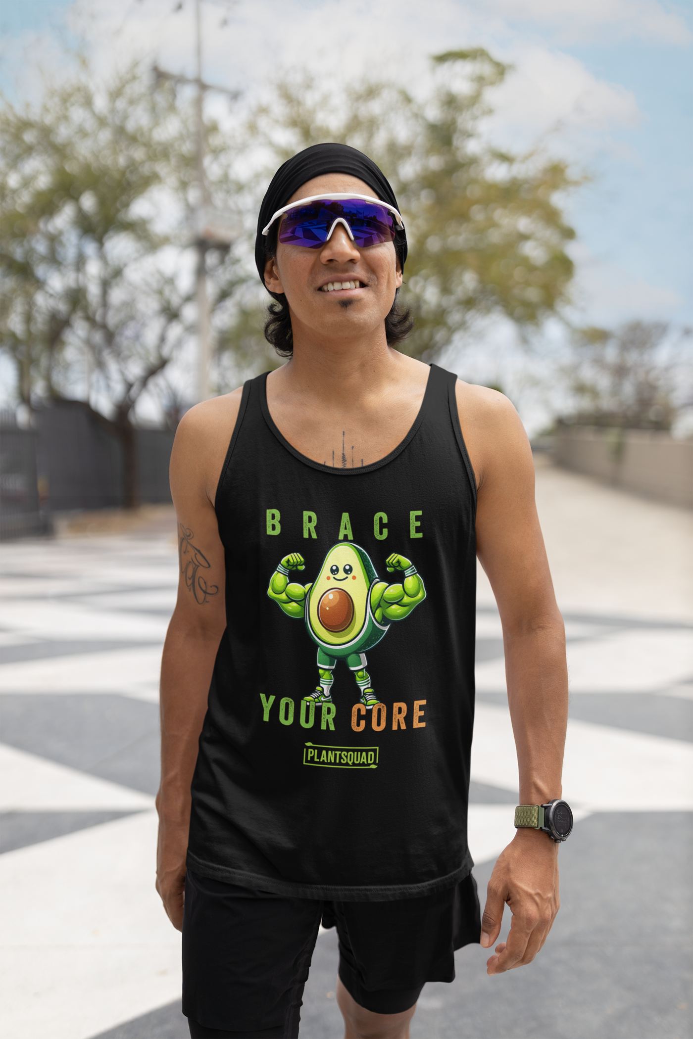 A Plantsquad Avocado "Brace Your Core" - Unisex Tank Top featuring a dynamic avocado cartoon flexing its biceps. The text above the avocado reads "BRACE," and below it reads "YOUR CORE" with "PLANTSQUAD" at the bottom. Perfect for those embracing a plant-based lifestyle and looking for stylish vegan gym wear.