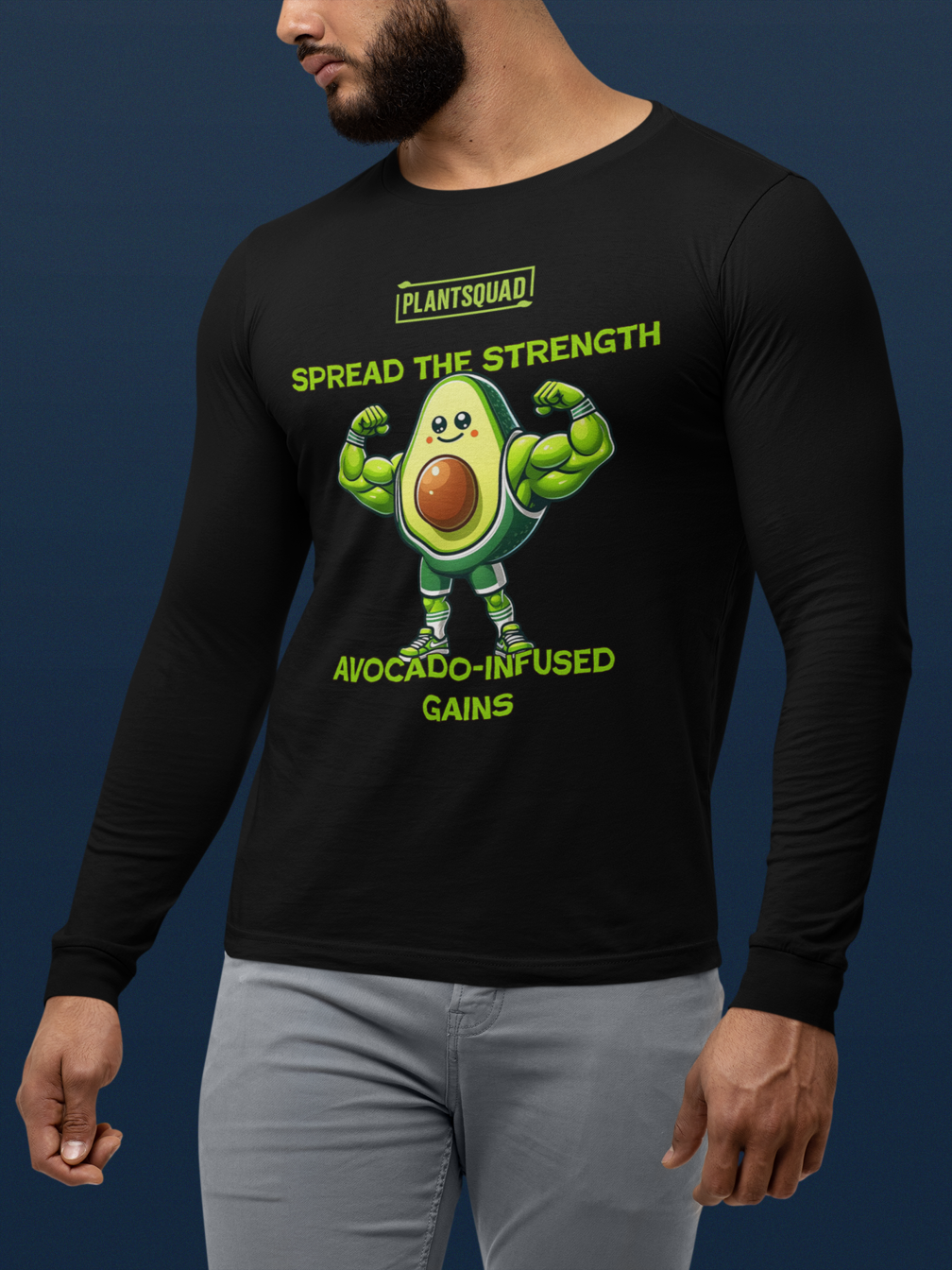 A black long-sleeve shirt features a muscular avocado cartoon flexing its arms. Above, it says "Plantsquad" and "Spread the Strength." Below the avocado, the text reads "Avocado-Infused Gains," perfect for fitness enthusiasts embracing a vegan lifestyle. This is the Plantsquad Avocado "Spread The Strength Avocado-Infused Gains" - Unisex Long Sleeve T-Shirt.