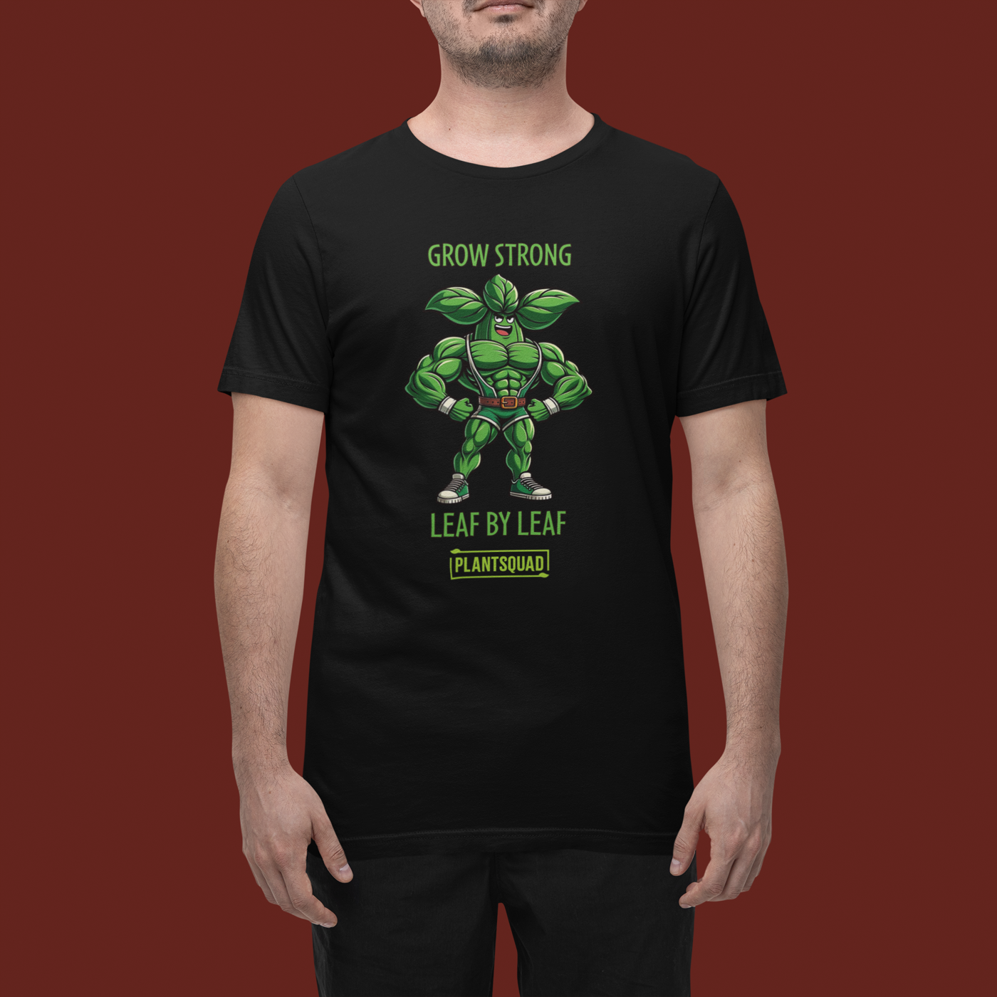 Plantsquad Basil "Grow Strong Leaf By Leaf" - Unisex T-Shirt featuring a muscular green superhero with leaves for ears and as part of his costume. Text above reads "Grow Strong" and below it says "Leaf By Leaf." The Plantsquad logo is proudly displayed at the bottom.