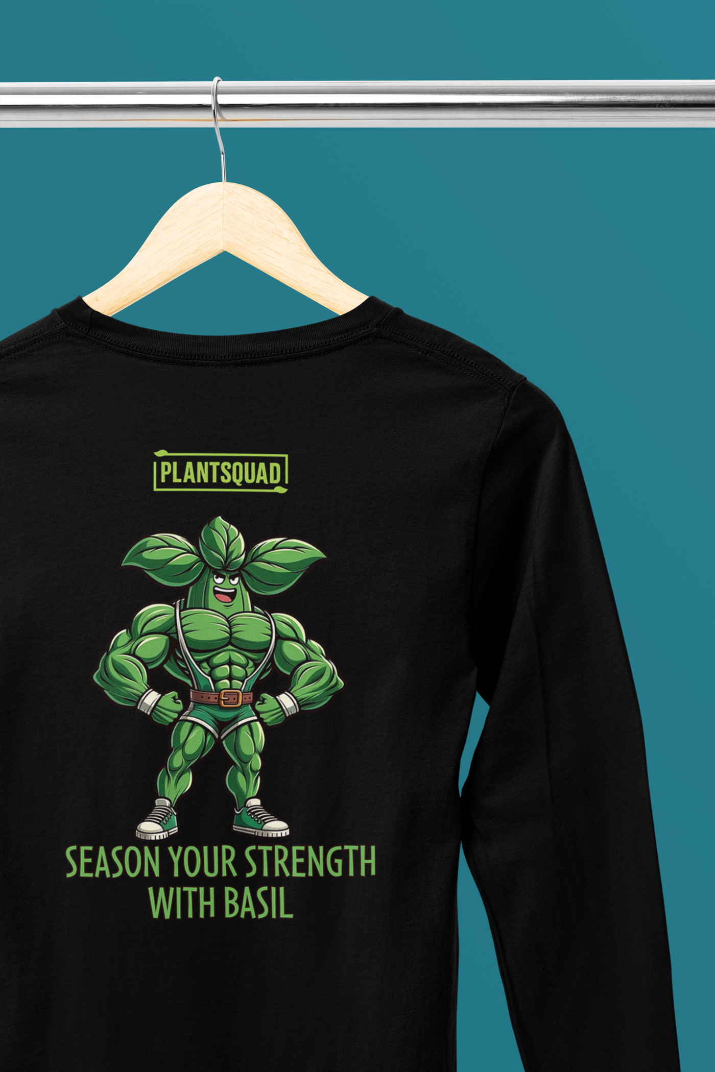 Black long-sleeve shirt with a graphic of a muscly basil cartoon in a green costume. Above the character, "PLANTSQUAD" is proudly displayed, and below, "SEASON YOUR STRENGTH WITH BASIL" appears in vibrant green letters. Perfect for fitness enthusiasts embracing a vegan lifestyle! Introducing the Plantsquad Basil "Season Your Strength With Basil" - Unisex Long Sleeve T-Shirt.