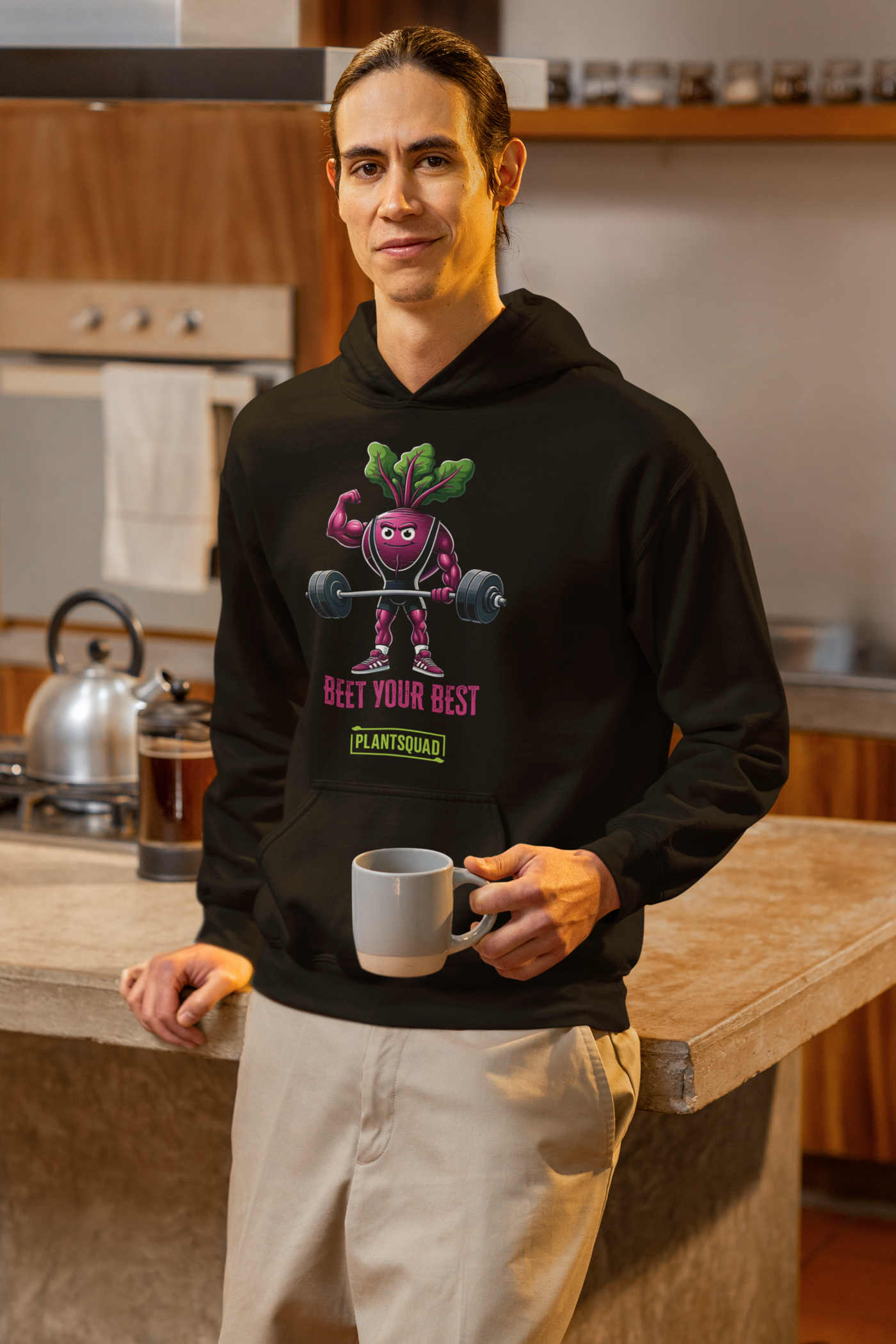 Enjoy the Plantsquad Beetroot "Beet Your Best" - Unisex Hoodie, a black hoodie made of cozy fabric featuring an illustrated beetroot lifting barbells, with leaves as hair, under the text "BEET YOUR BEST" in bold pink letters. Embrace your vegan lifestyle with the small green box below the beetroot character that reads "PLANTSQUAD.