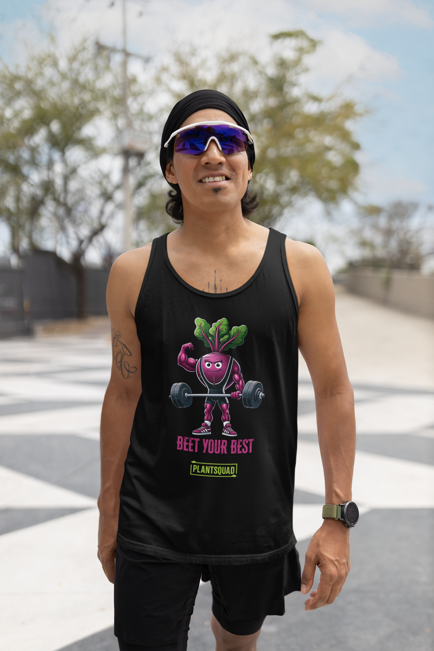 The Plantsquad Beetroot "Beet Your Best" - Unisex Tank Top features an illustration of a muscular beetroot character lifting a barbell. The text below the character reads "BEET YOUR BEST" in red and "PLANTSQUAD" in green. Perfect for gym enthusiasts embracing a plant-based lifestyle.