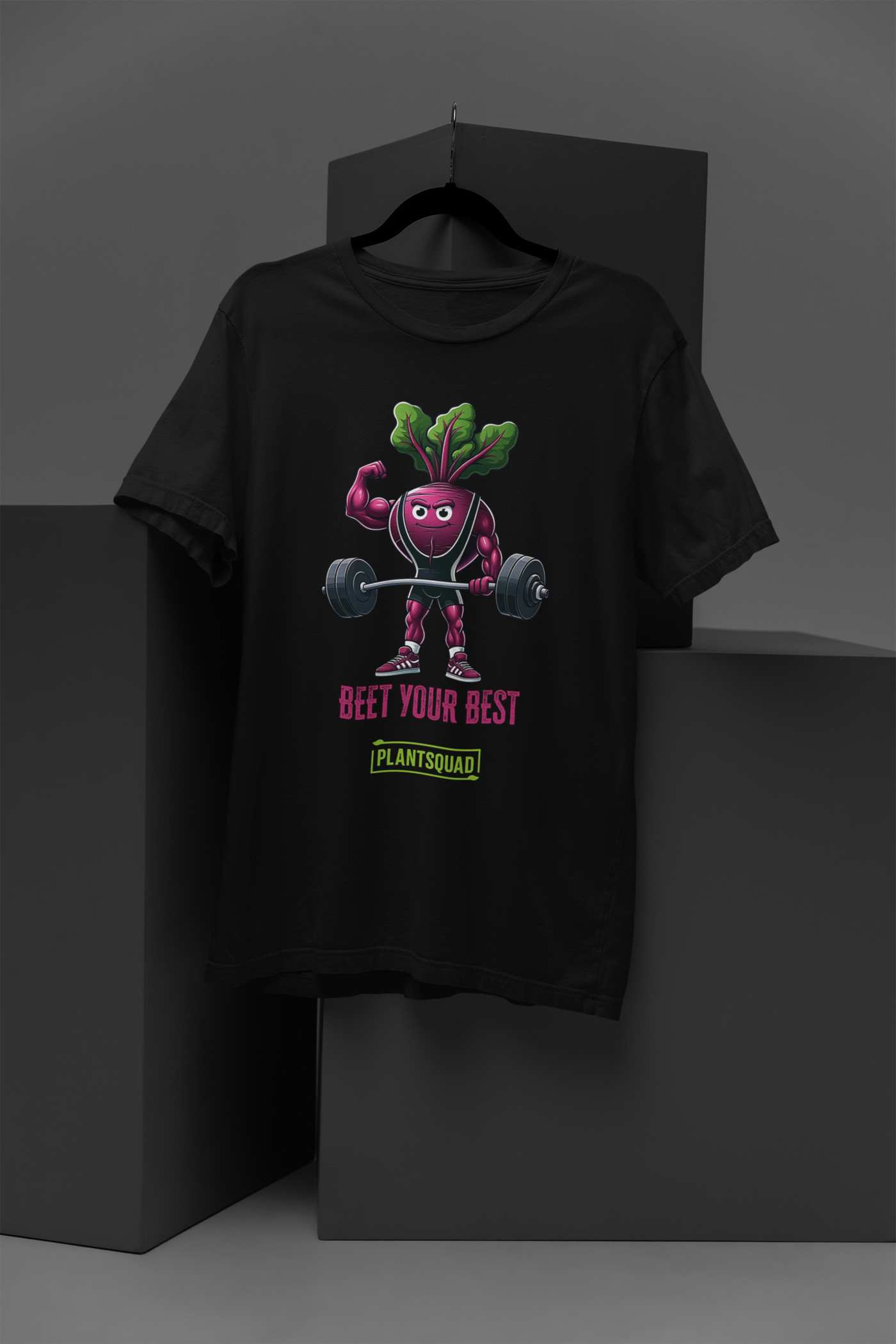 A Plantsquad Beetroot "Beet Your Best" - Unisex T-Shirt featuring a cartoon beetroot lifting weights with a determined expression. Above the beetroot, the text reads, "BEET YOUR BEST," while below it, "PLANTSQUAD" is showcased in a green box.