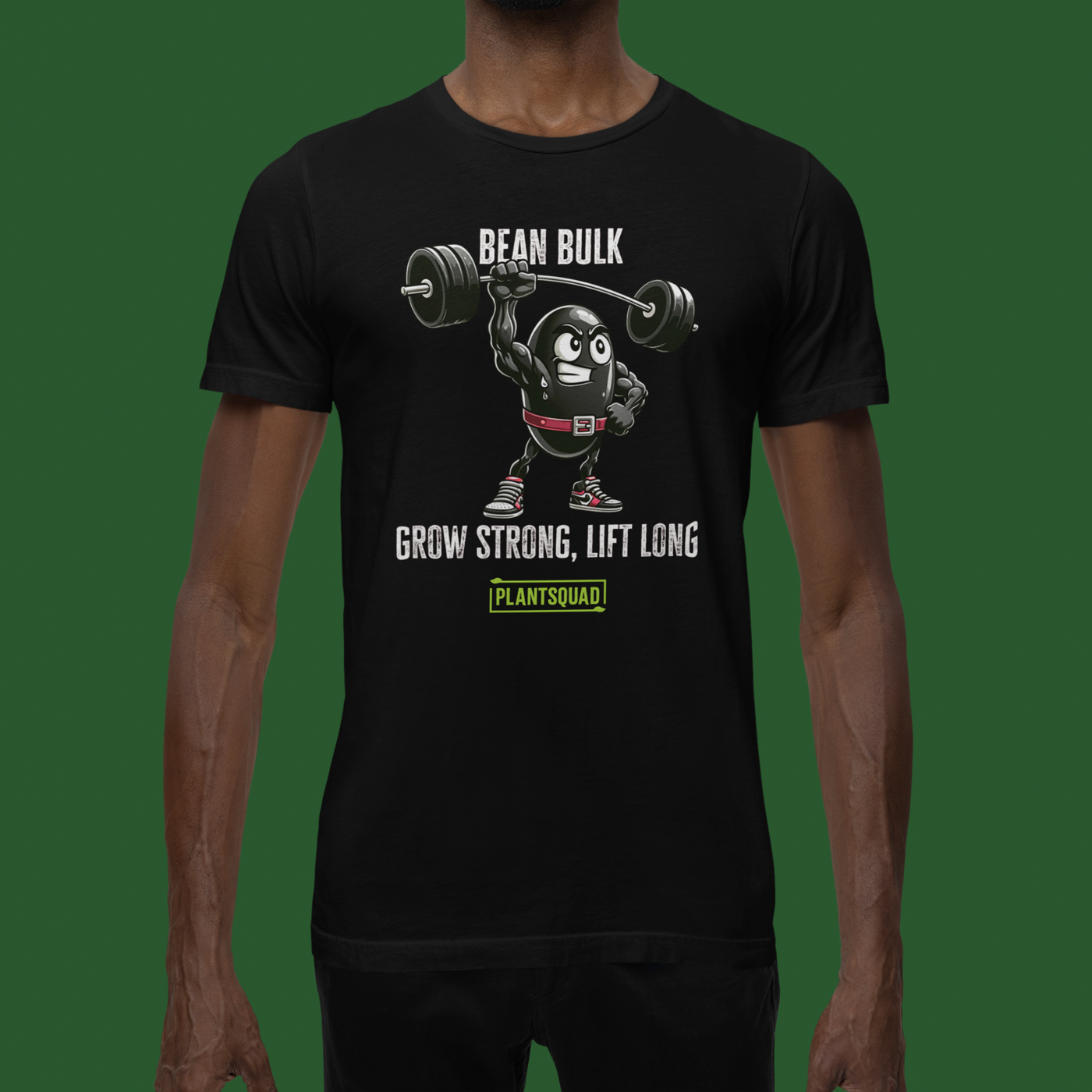 The Plantsquad Black Bean "Bean Bulk Grow Strong Lift Long" - Unisex T-Shirt features a muscular cartoon bean character lifting a barbell. The text above the character reads "Bean Bulk" and below it says "Grow Strong, Lift Long." Proudly show your loyalty to the Plantsquad with the word displayed in a green box at the bottom.