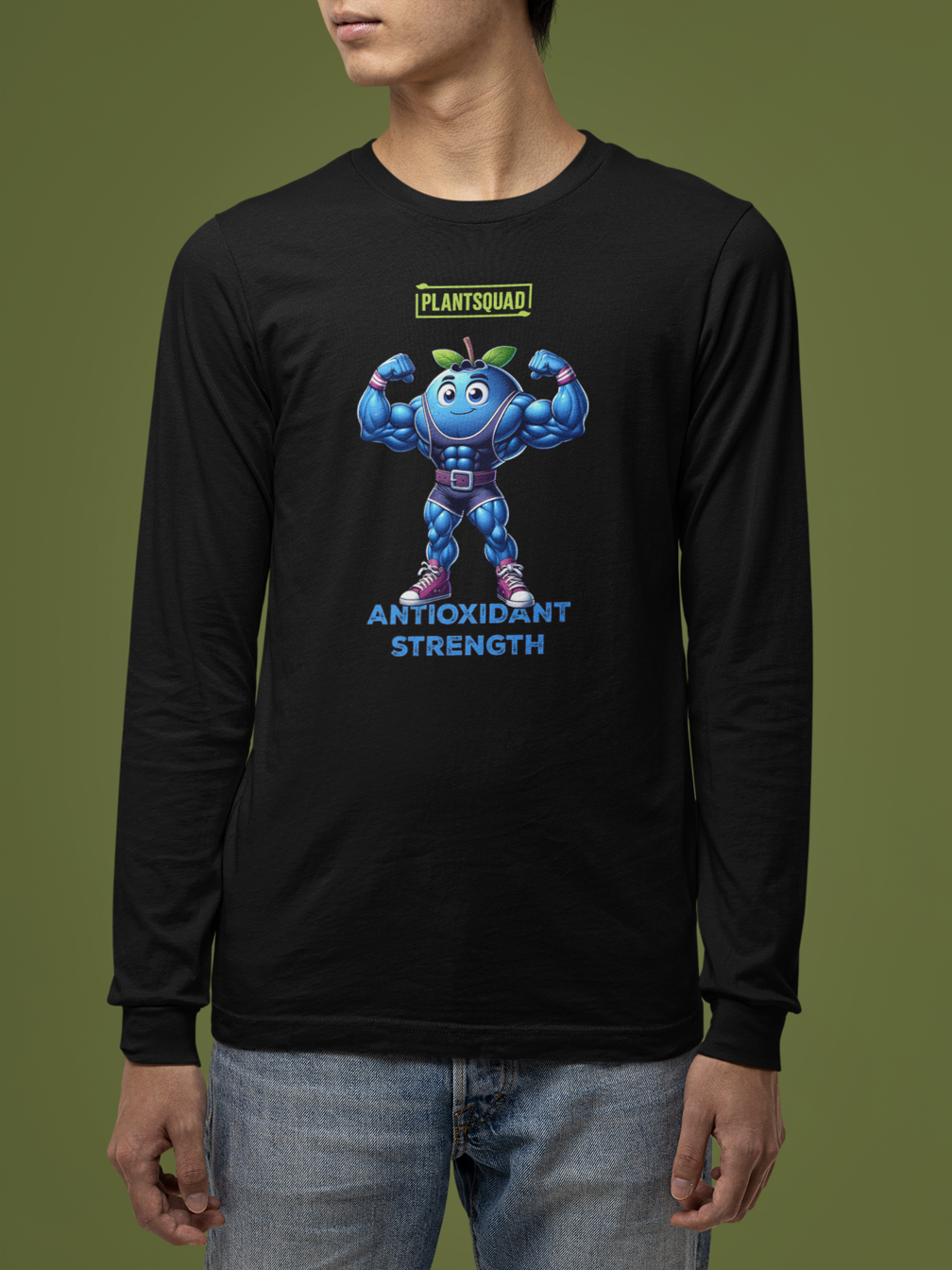 Product Description: Plantsquad Blueberry "Antioxidant Strength" - Unisex Long Sleeve T-Shirt featuring an illustrated blue, muscular cartoon superhero resembling a muscly blueberry with antennas, flexing its arms. Above the character, the text reads "PLANTSQUAD," and below, it says "ANTIOXIDANT STRENGTH" in blue letters. Perfect for promoting a plant-based lifestyle and vegan fitness.