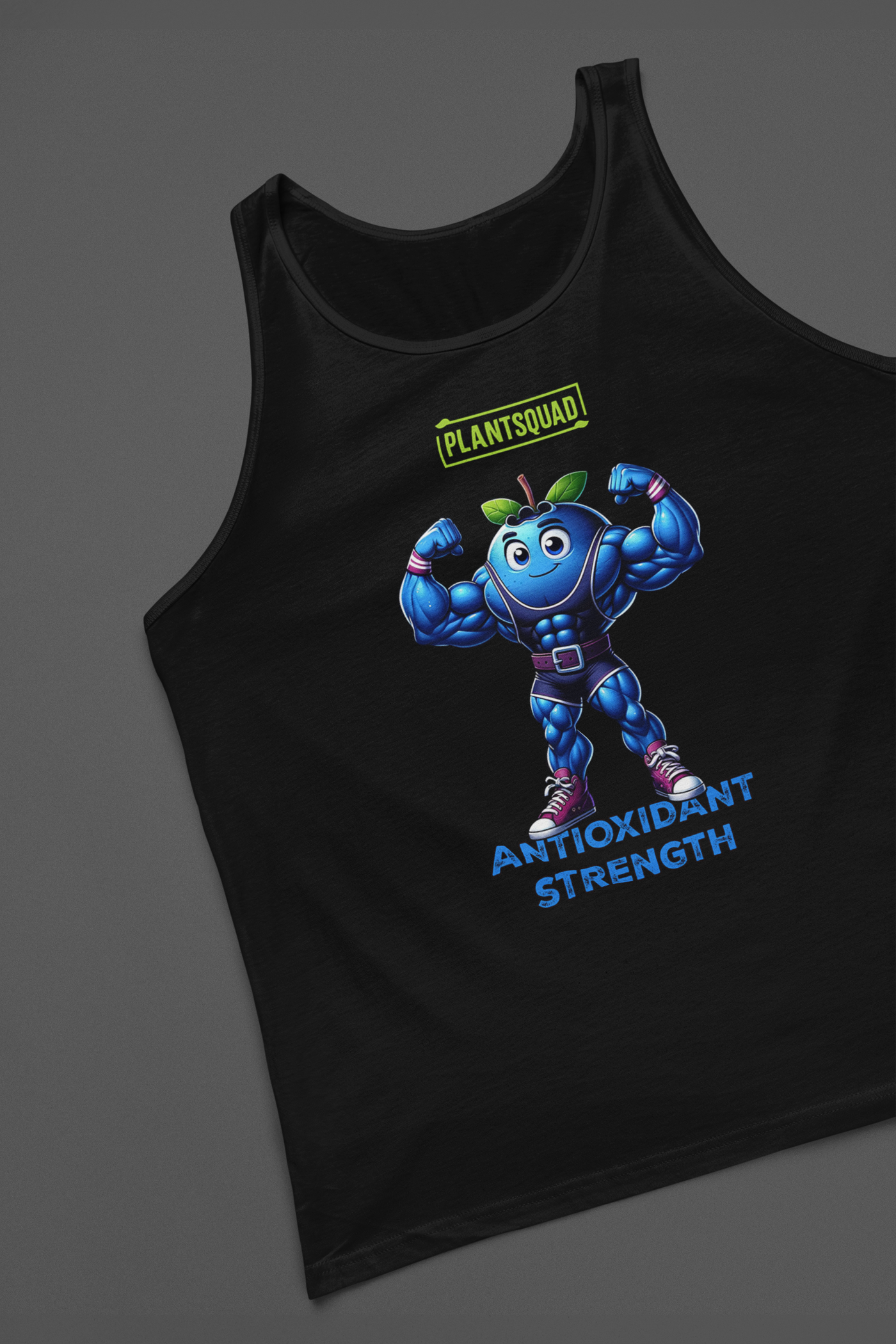 A black **Plantsquad Blueberry "Antioxidant Strength" - Unisex Tank Top** featuring a muscly blueberry cartoon flexing its arms. Above the blueberry, the word "Plantsquad" is displayed in a green box. Below the character, the words "Antioxidant Strength" are written in blue. Perfect for embracing a vegan lifestyle with premium breathable fabric for ultimate comfort.