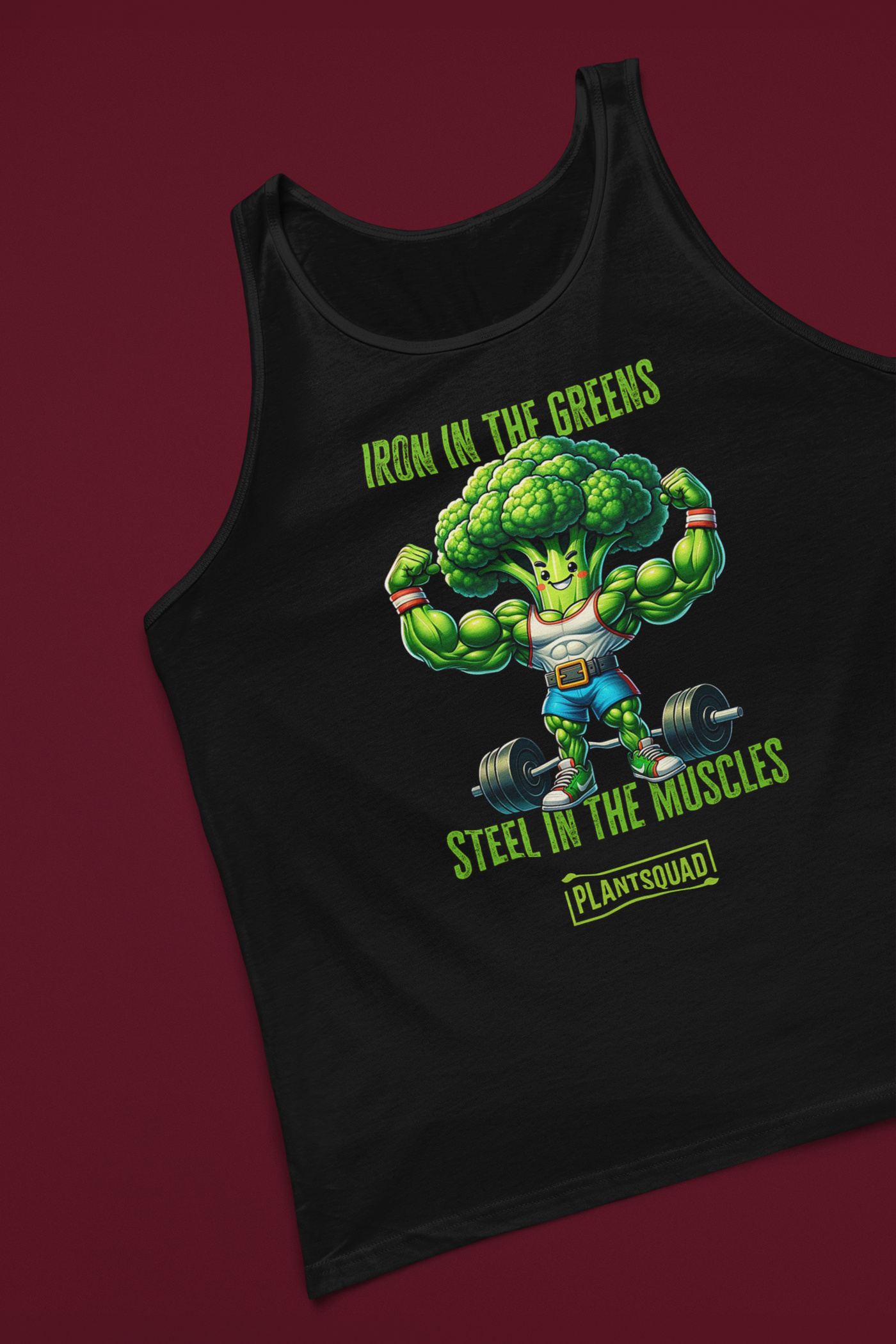 The Plantsquad Broccoli "Iron In The Greens Steel In The Muscles" - Unisex Tank Top features an illustration of a muscular broccoli character lifting weights. The text above reads "Iron in the Greens" and below reads "Steel in the Muscles" with "Plantsquad" at the bottom—perfect for gym enthusiasts embracing a plant-based lifestyle.