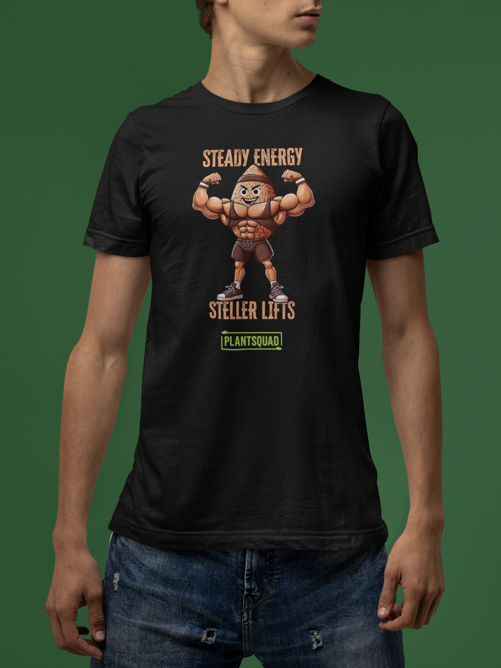 A black t-shirt features an illustration of a muscular peanut character flexing its arms. Above the character, text reads "STEADY ENERGY," and below, text reads "STELLAR LIFTS." A green box at the bottom proudly displays the word "Plantsquad Brown Rice 'Steady Energy Stellar Lifts' - Unisex T-Shirt.