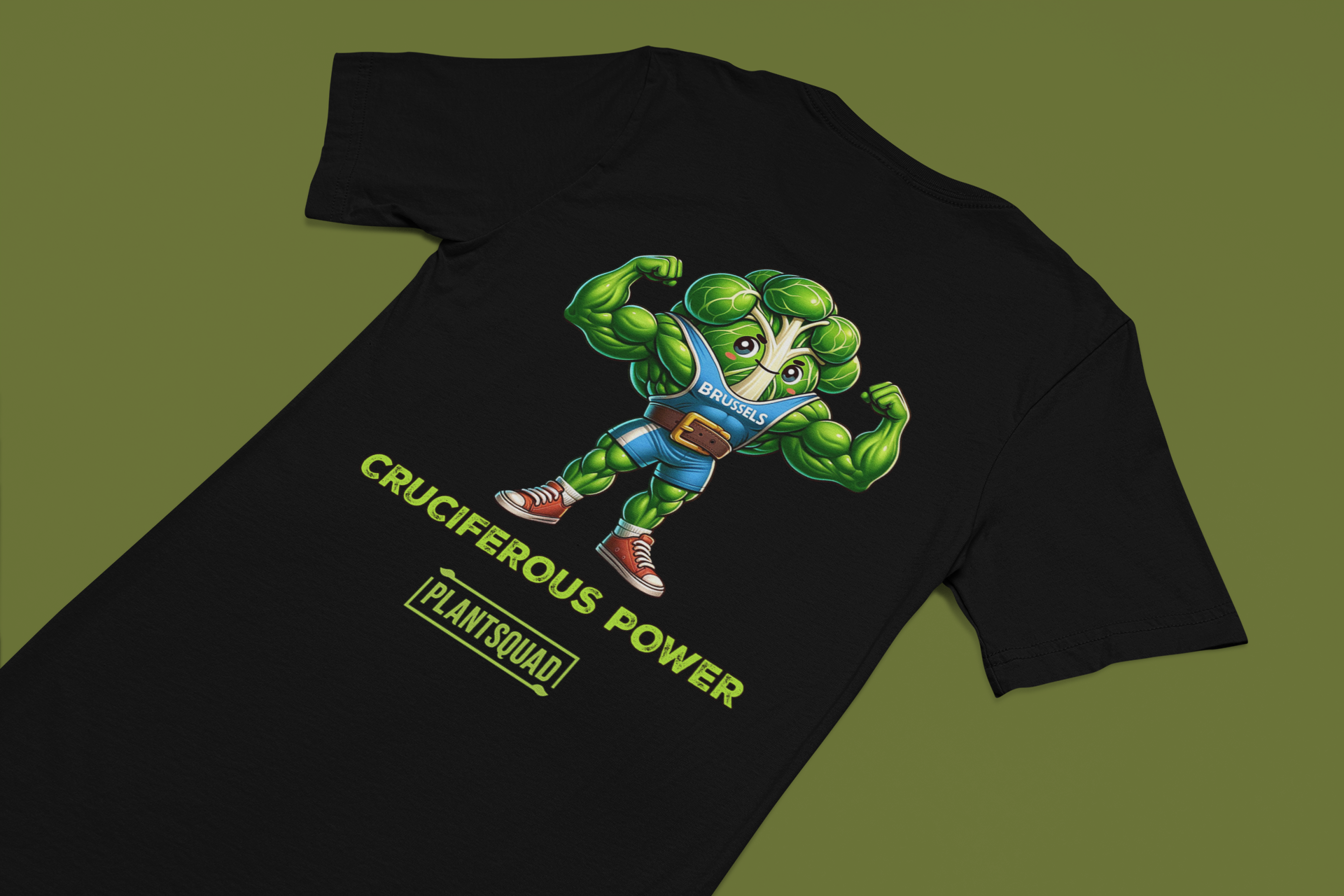 A Plantsquad Brussel Sprout "Cruciferous Power" - Unisex T-Shirt features a muscular cartoon broccoli character in a blue top flexing its biceps. Below the character, bold text reads "CRUCIFEROUS POWER", while underneath in smaller text is the keyword hashtag "plantsquad".