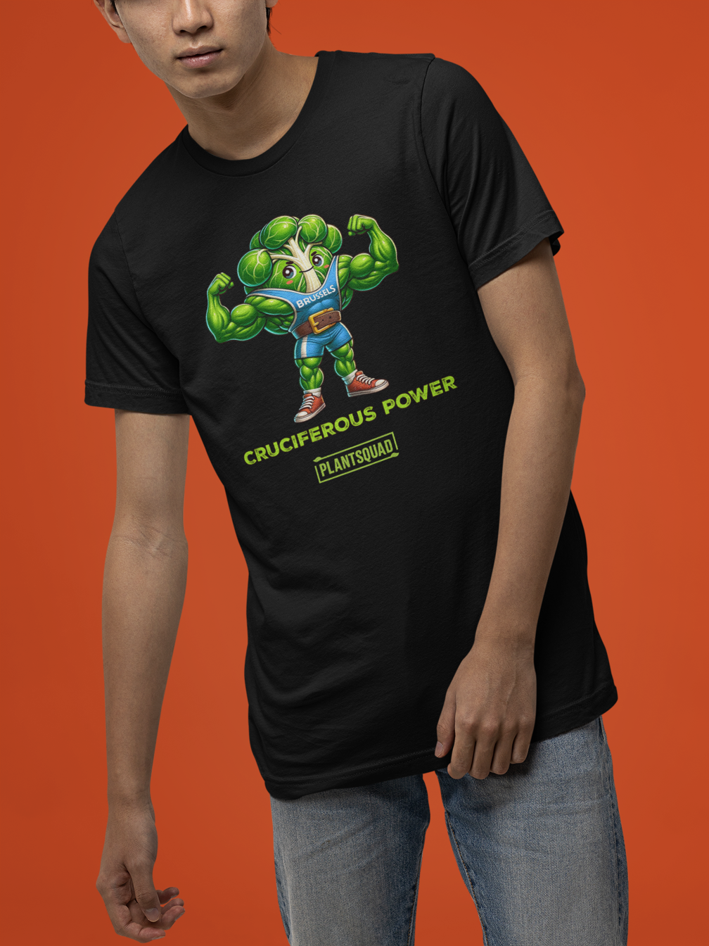 A Plantsquad Brussel Sprout "Cruciferous Power" - Unisex T-Shirt features a muscular cartoon broccoli character in a blue top flexing its biceps. Below the character, bold text reads "CRUCIFEROUS POWER", while underneath in smaller text is the keyword hashtag "plantsquad".