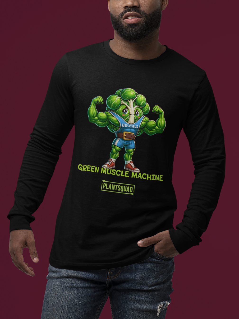 A Plantsquad Brussel Sprout "Green Muscle Machine" - Unisex Long Sleeve T-Shirt featuring a muscly Brussels sprout cartoon flexing its biceps. It wears a blue tank top labeled "BRUSSELS" and has text below that reads, "GREEN MUSCLE MACHINE" and "PLANTSQUAD." The design is vibrant and playful, making it perfect for those embracing a plant-based lifestyle.