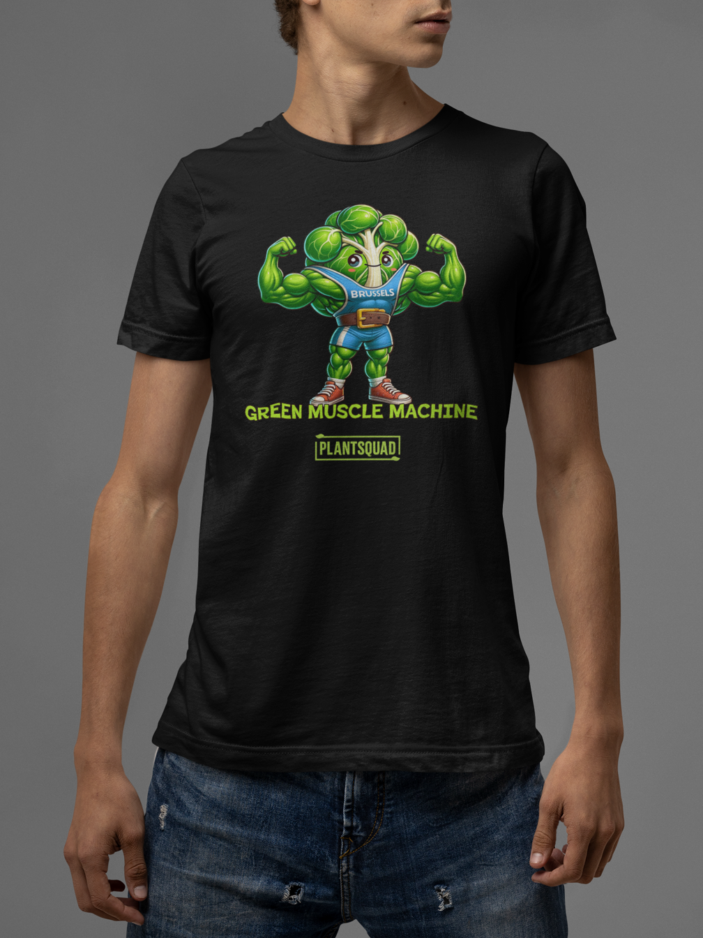 The Plantsquad Brussel Sprout "Green Muscle Machine" - Unisex T-Shirt showcases a muscular, anthropomorphic green broccoli character in a blue tank top flexing its arms. Below the character, the words "GREEN MUSCLE MACHINE" and "#PLANTSQUAD" are emblazoned in vibrant green text.