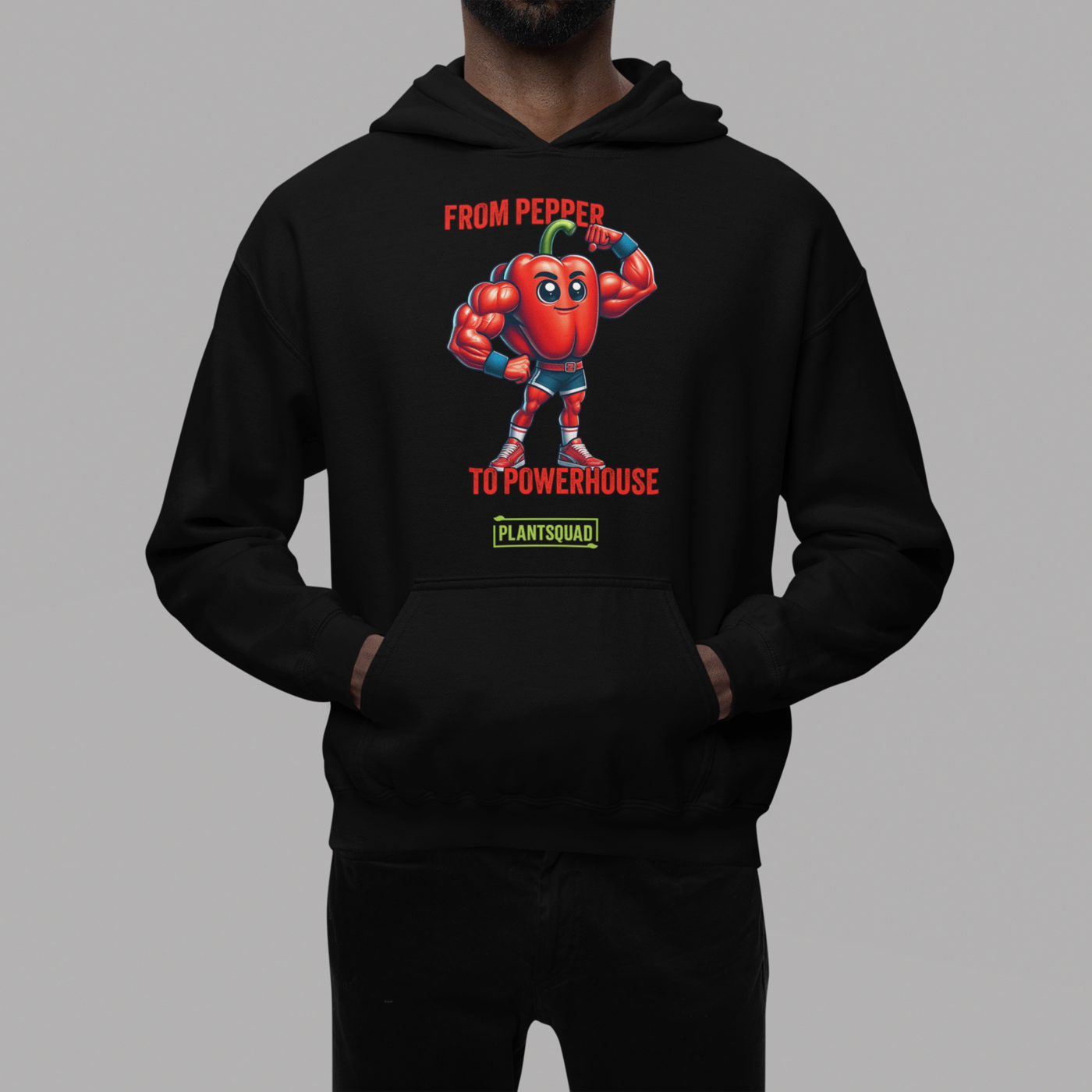 Plantsquad Capsicum "From Pepper To Powerhouse" - Unisex Hoodie featuring a cartoon image of a muscular red pepper wearing boxing gloves and shorts. The text above the character reads "FROM PEPPER TO POWERHOUSE" and below it, "PLANTSQUAD" is written on a green banner, celebrating the vegan lifestyle and plant-based power in weight lifting.