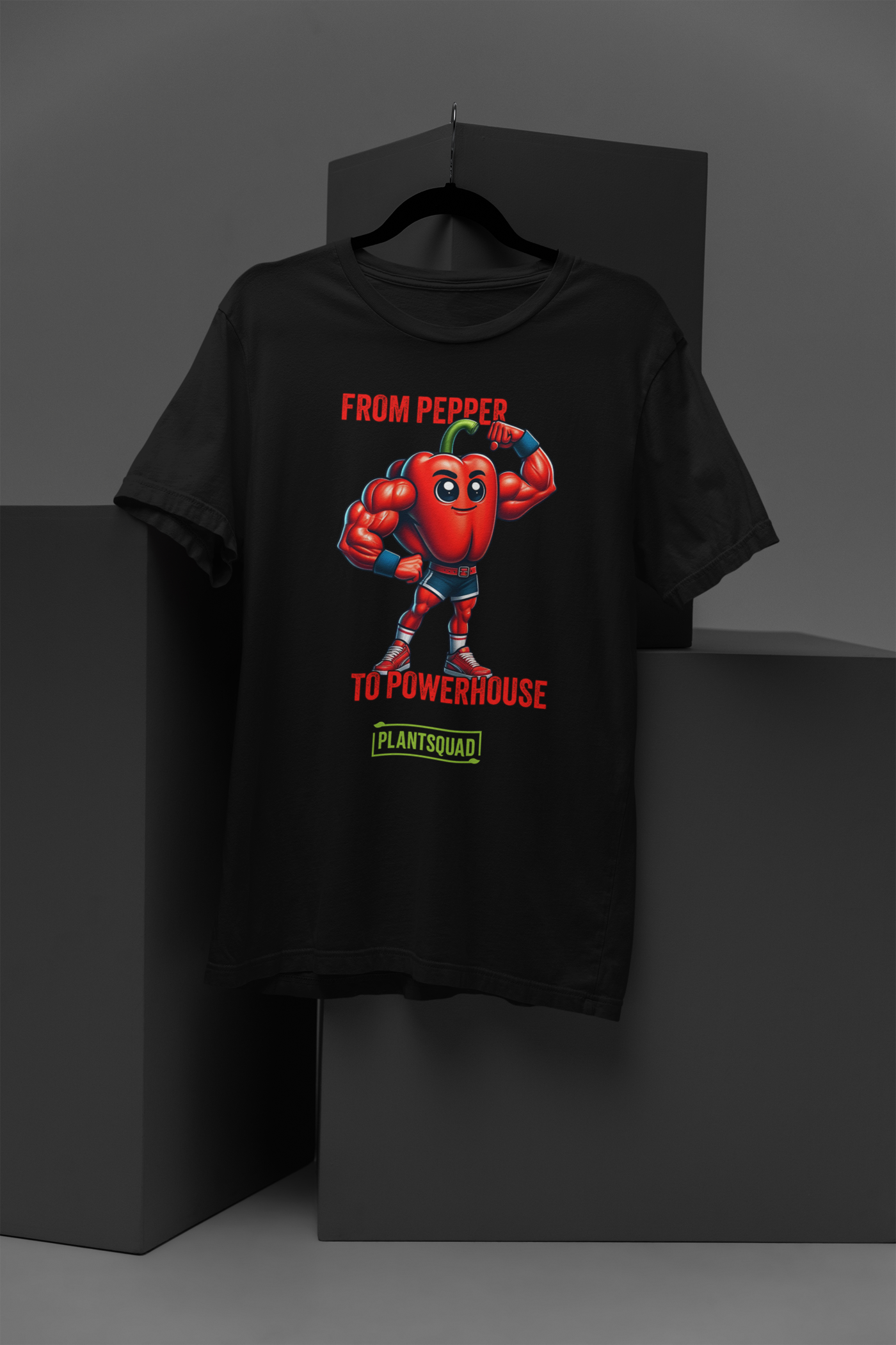 The Plantsquad Capsicum "From Pepper To Powerhouse" - Unisex T-Shirt features a muscular cartoon red bell pepper wearing a superhero outfit with a blue mask and gloves. The text above the character reads "FROM PEPPER TO POWERHOUSE" and below it, #PLANTSQUAD is displayed in a green box.