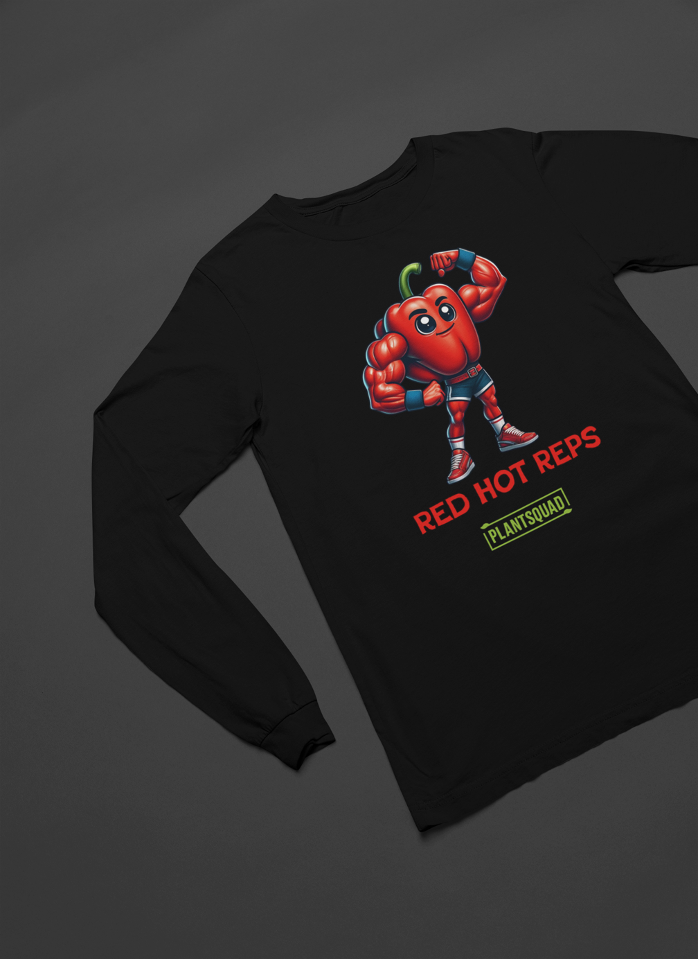 A Plantsquad Capsicum "From Pepper To Powerhouse" - Unisex Long Sleeve T-Shirt featuring a cartoon of a muscular red pepper with a green stem, flexing its biceps. Perfect for fitness enthusiasts, the text above reads "From Pepper To Powerhouse" and below reads "PlantSquad," celebrating the plant-based, vegan lifestyle.