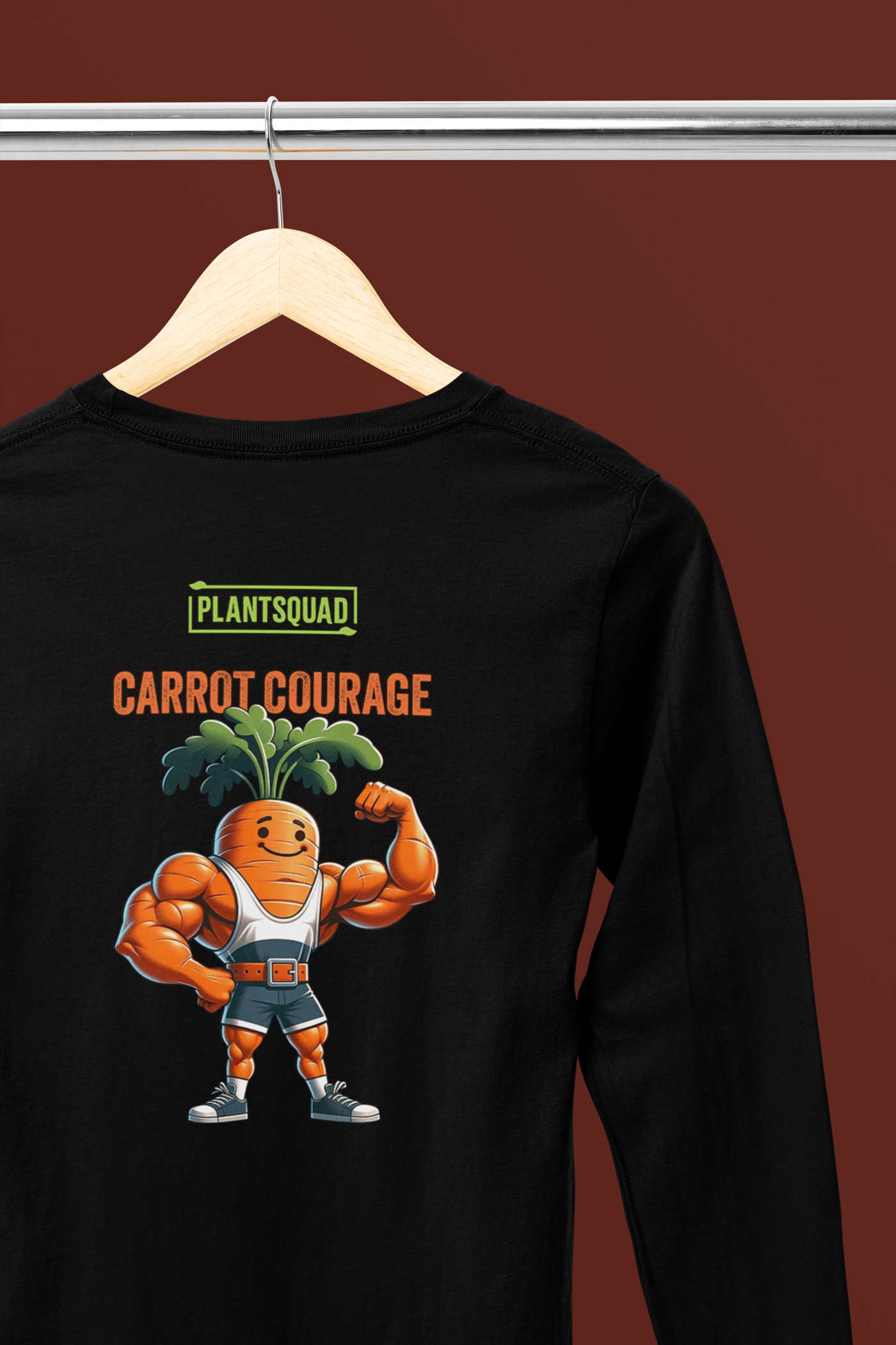 A Plantsquad Carrot "Carrot Courage" - Unisex Long Sleeve T-Shirt featuring a muscular cartoon carrot character flexing its arm muscles. The character has green leafy hair and is wearing orange and white sneakers. Perfect for fitness enthusiasts embracing a vegan lifestyle, the text above reads "PLANT SQUAD" and "CARROT COURAGE.