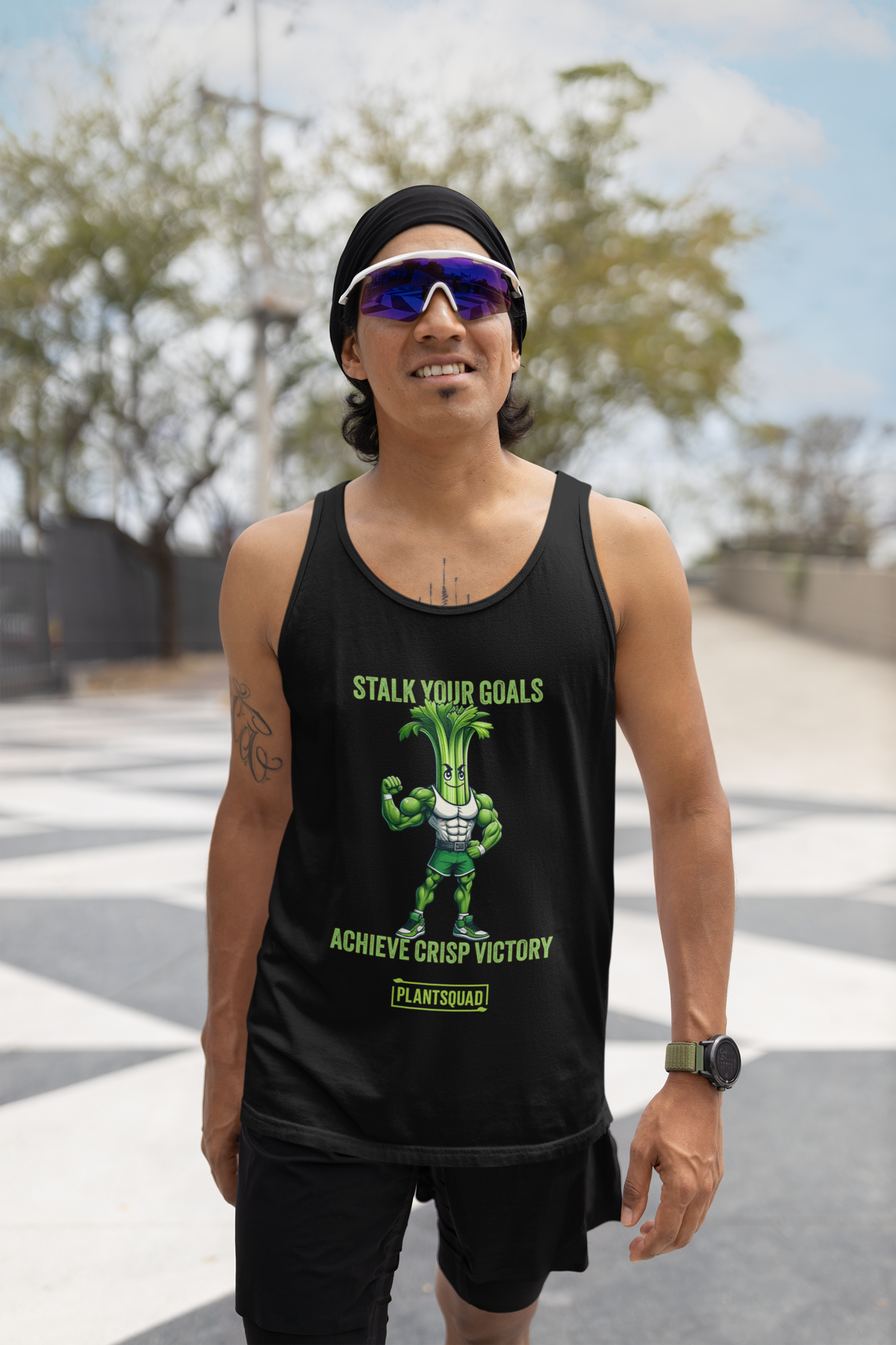 A Plantsquad Celery "Stalk Your Goals Achieve Crisp Victory" - Unisex Tank Top featuring an animated muscular celery character with a green body and determined expression. Above and below the character are the phrases, "Stalk Your Goals" and "Achieve Crisp Victory," respectively, in green text. This premium workout tank top is perfect for those embracing a plant-based lifestyle. A "PlantSquad" logo is at the bottom.