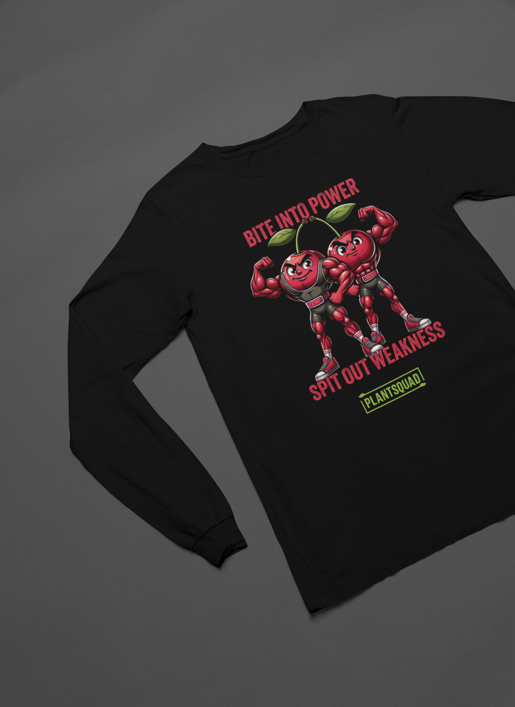 A Plantsquad Cherries "Bite Into Power Spit Out Weakness" - Unisex Long Sleeve T-Shirt featuring two muscular, anthropomorphic cherries flexing their arms. The text reads "Bite into Power, Spit out Weakness" above the muscly cherries cartoon, and "Plant Squad" below them, perfect for showcasing your commitment to a plant-based lifestyle.