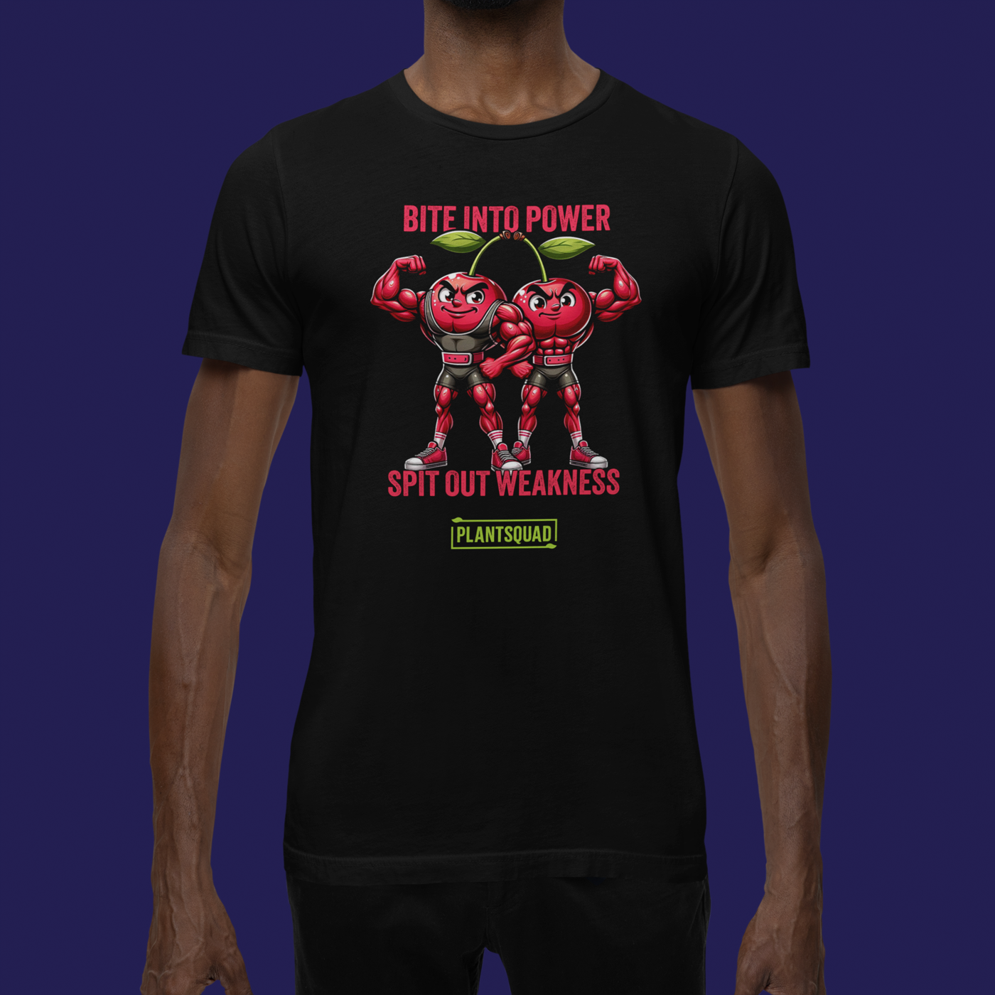 A black Plantsquad Cherries "Bite Into Power Spit Out Weakness" - Unisex T-shirt features two muscular cartoon cherries flexing their arms. Above them, pink text reads "Bite Into Power." Below them, white text reads "Spit Out Weakness." At the bottom, there's a green and yellow Plantsquad logo.