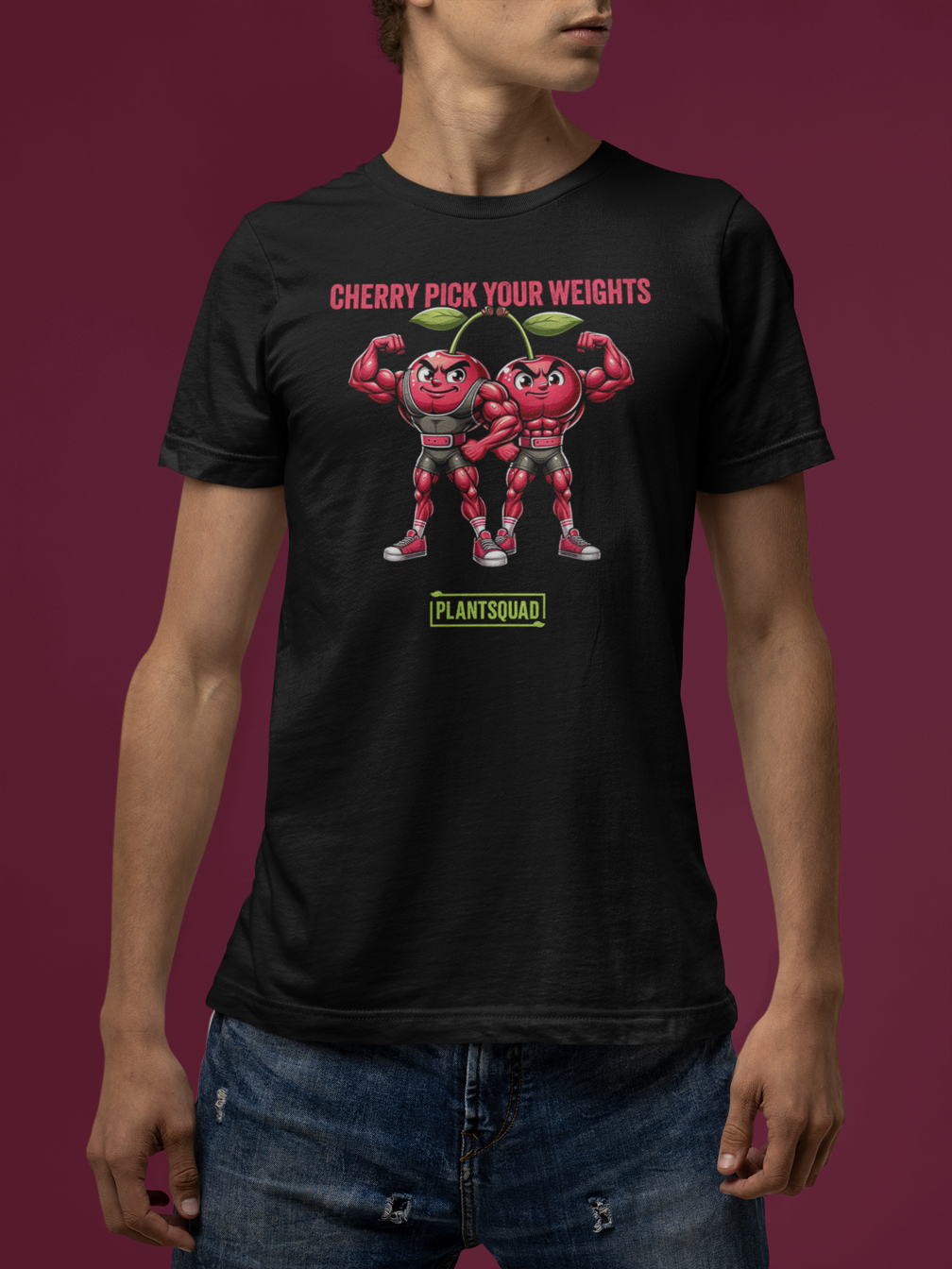 A Plantsquad Cherries "Cherry Pick Your Weights" - Unisex T-Shirt features two muscular cartoon cherries flexing their arms. Above them, red text reads, "CHERRY PICK YOUR WEIGHTS." Below the cherries, green text inside a box proudly displays, "PLANTSQUAD.