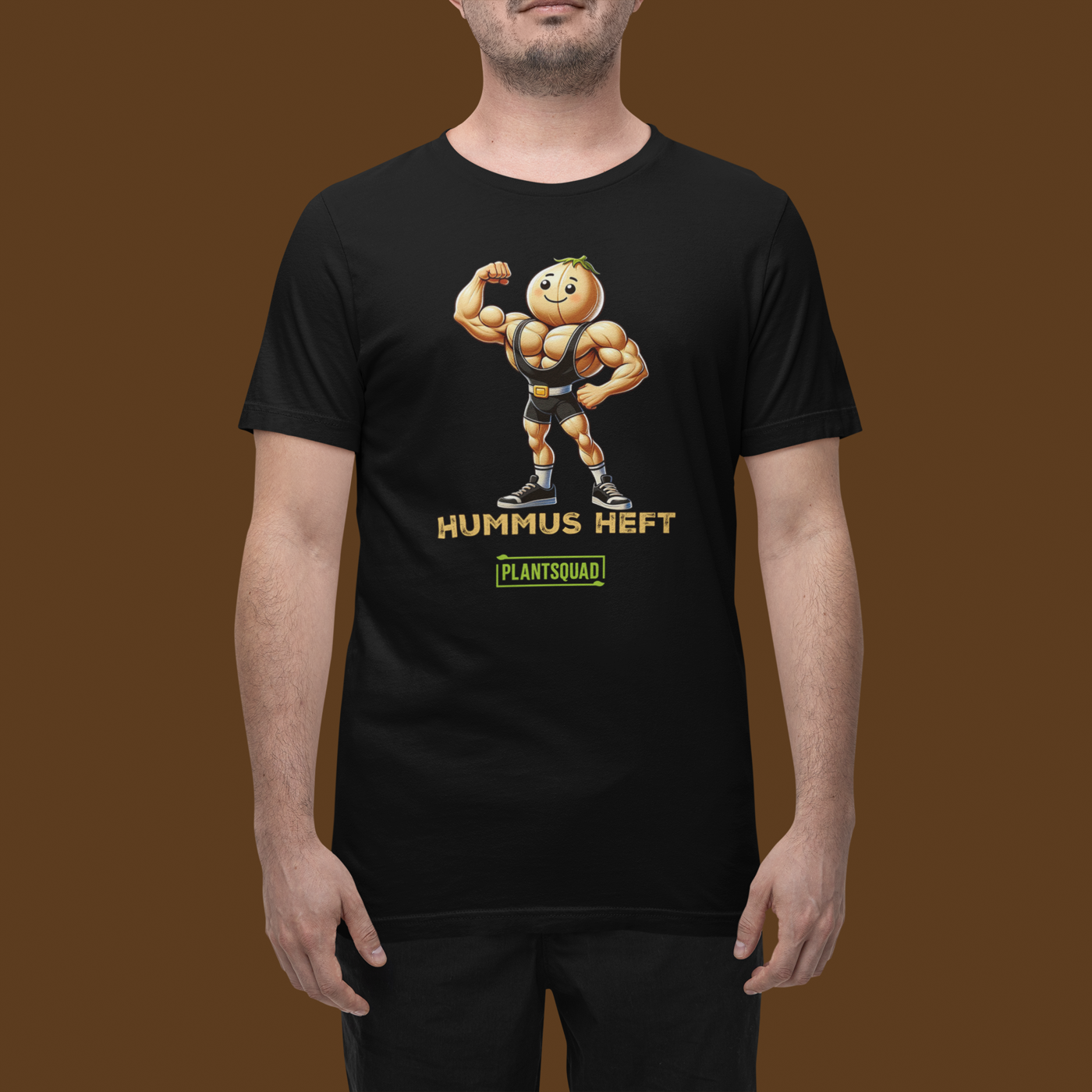 A Plantsquad Chickpea "Hummus Heft" - Unisex T-Shirt featuring a muscular chickpea character flexing its arms. Below the character, the text proudly reads, "HUMMUS HEFT" and "#PLANTSQUAD." The character and text are printed in vibrant yellow and white, adding striking contrast to the black shirt.